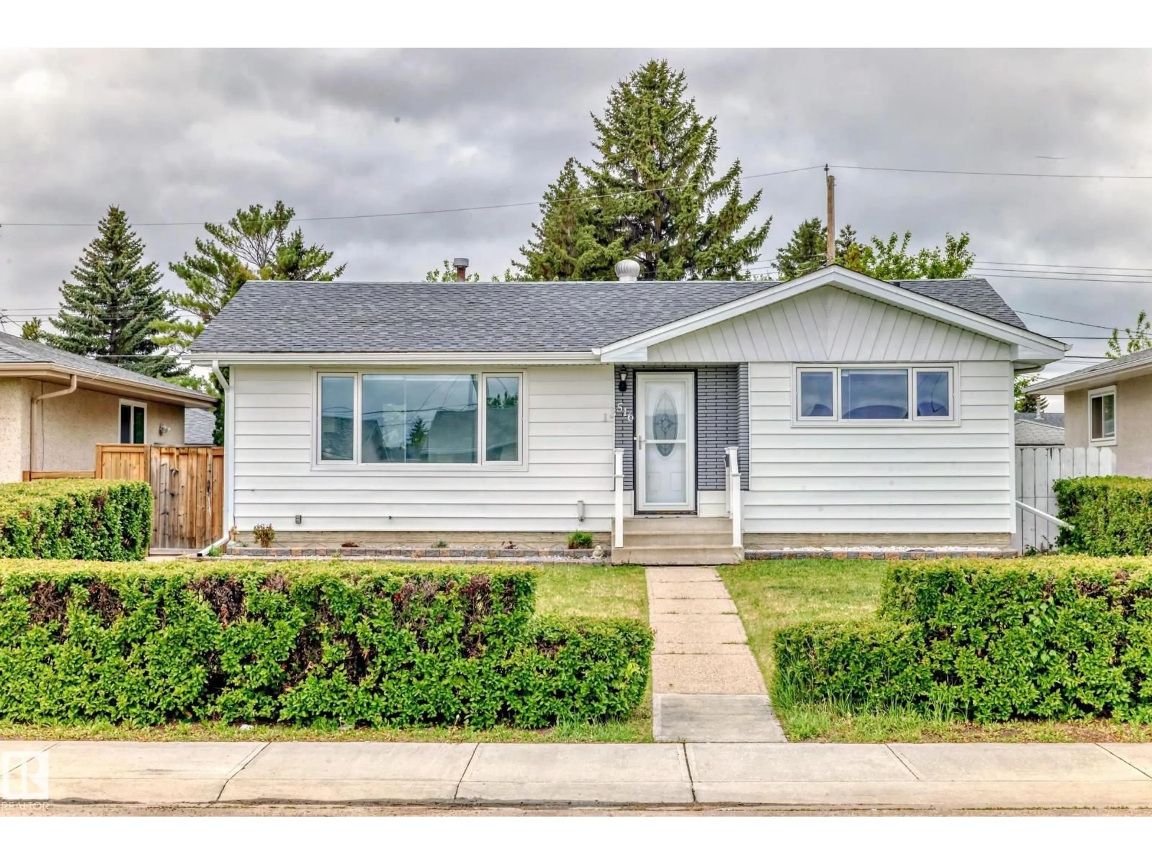 Home with vinyl exterior material, street for 13516 112 ST NW, Edmonton Alberta T5E5A4