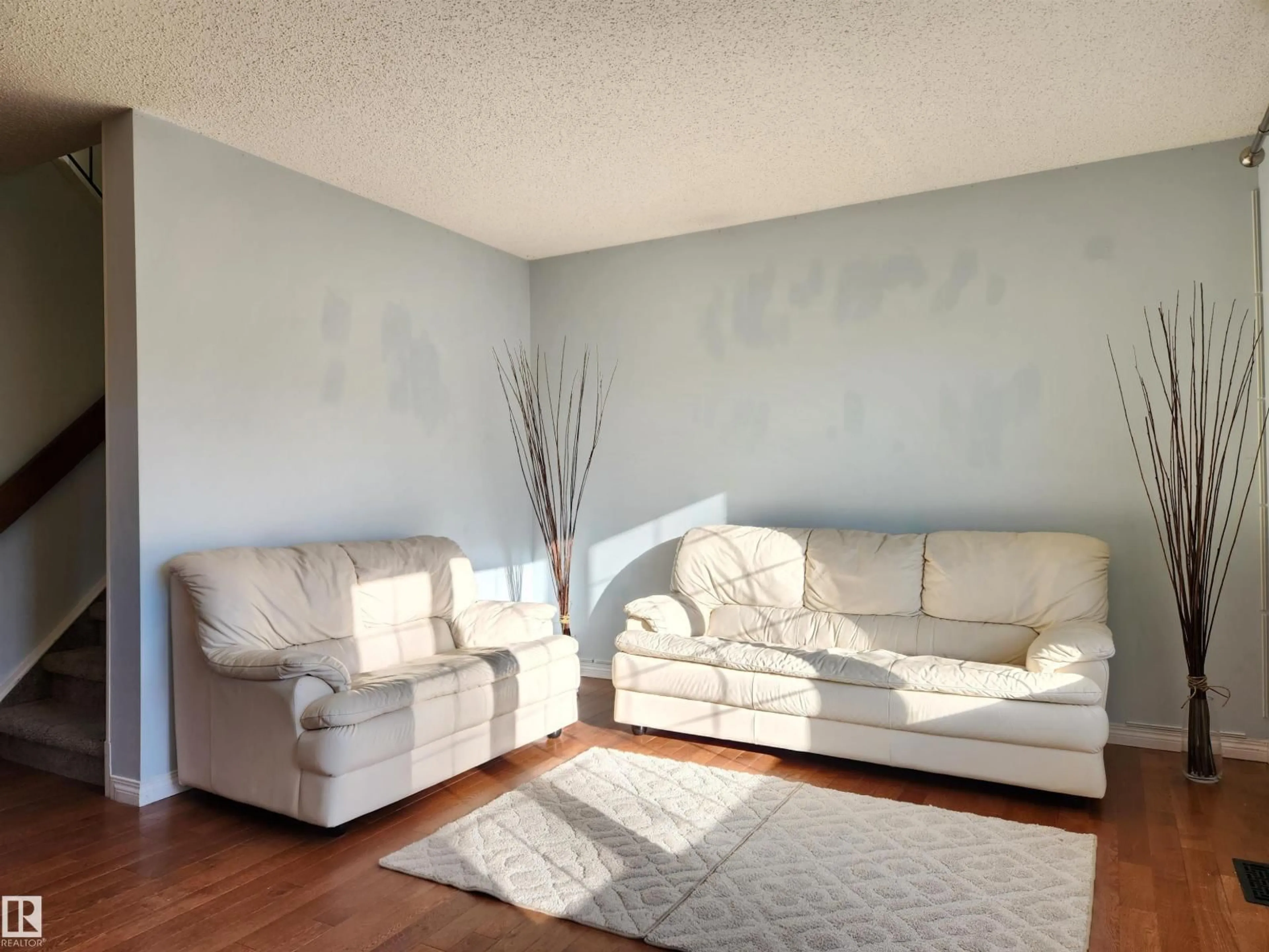 Living room with furniture, wood/laminate floor for 4138 36 ST, Edmonton Alberta T6L5M6