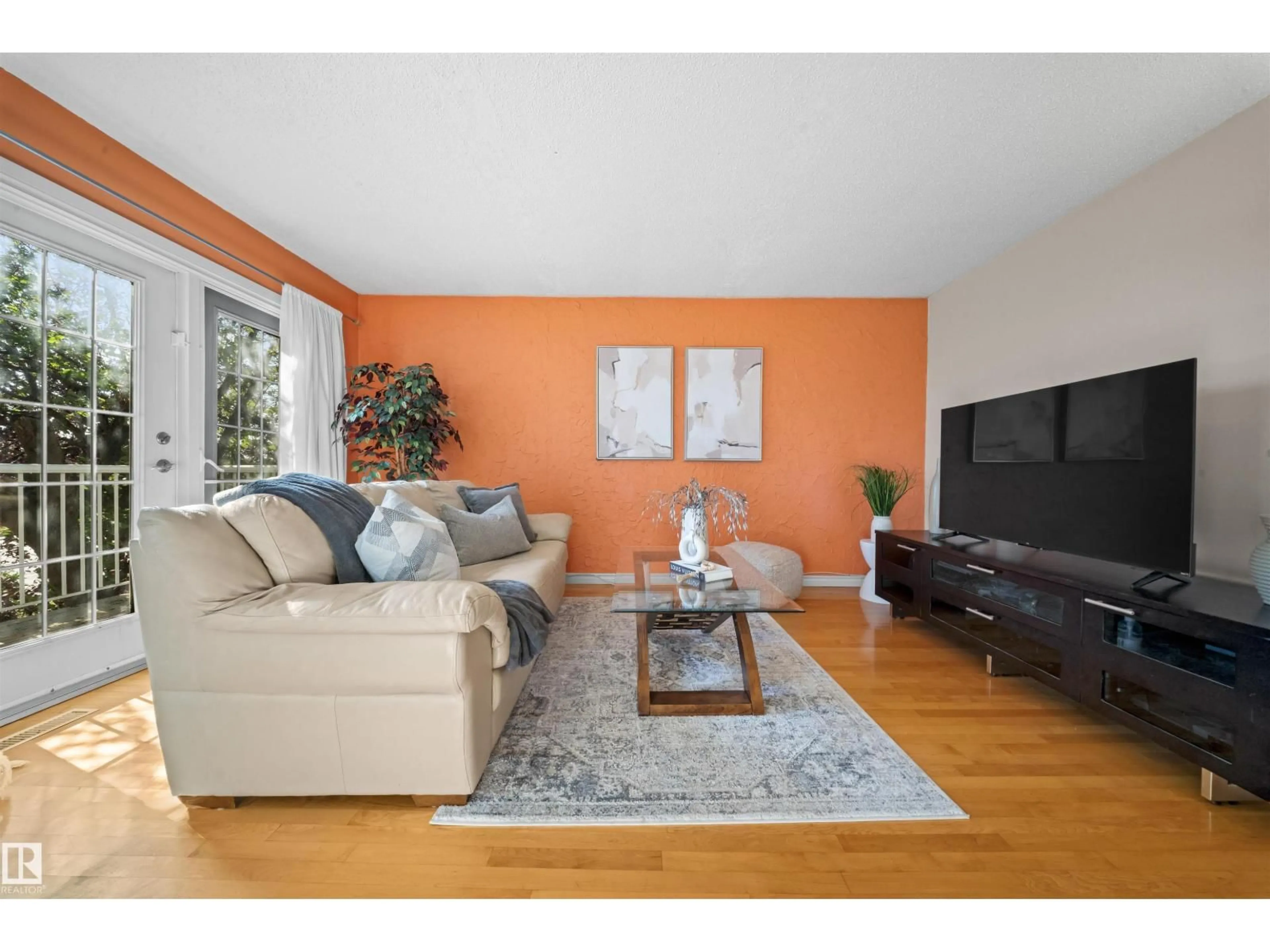 Living room with furniture, wood/laminate floor for 11604 127 AV, Edmonton Alberta T5E0C8