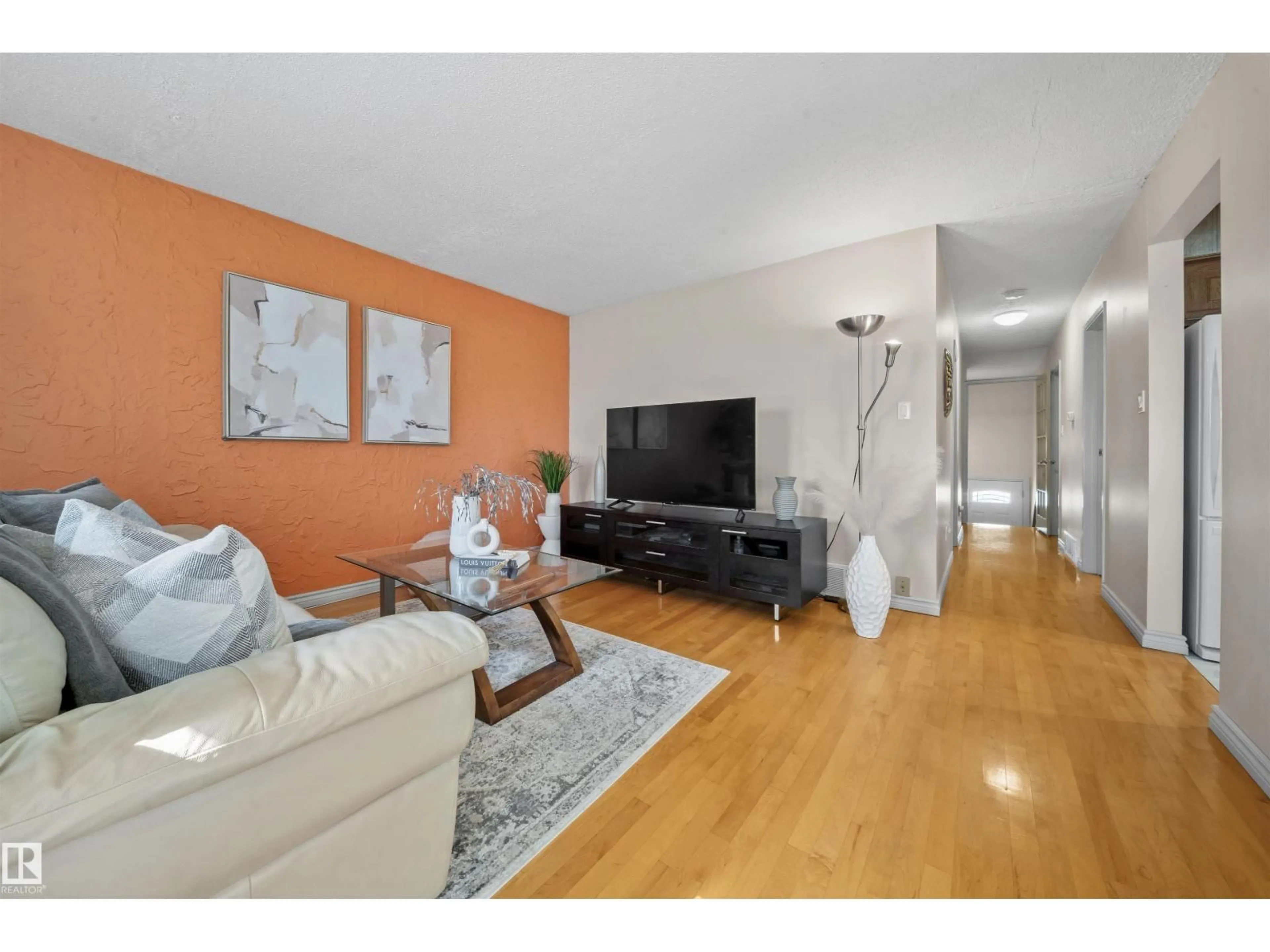 Living room with furniture, wood/laminate floor for 11604 127 AV, Edmonton Alberta T5E0C8