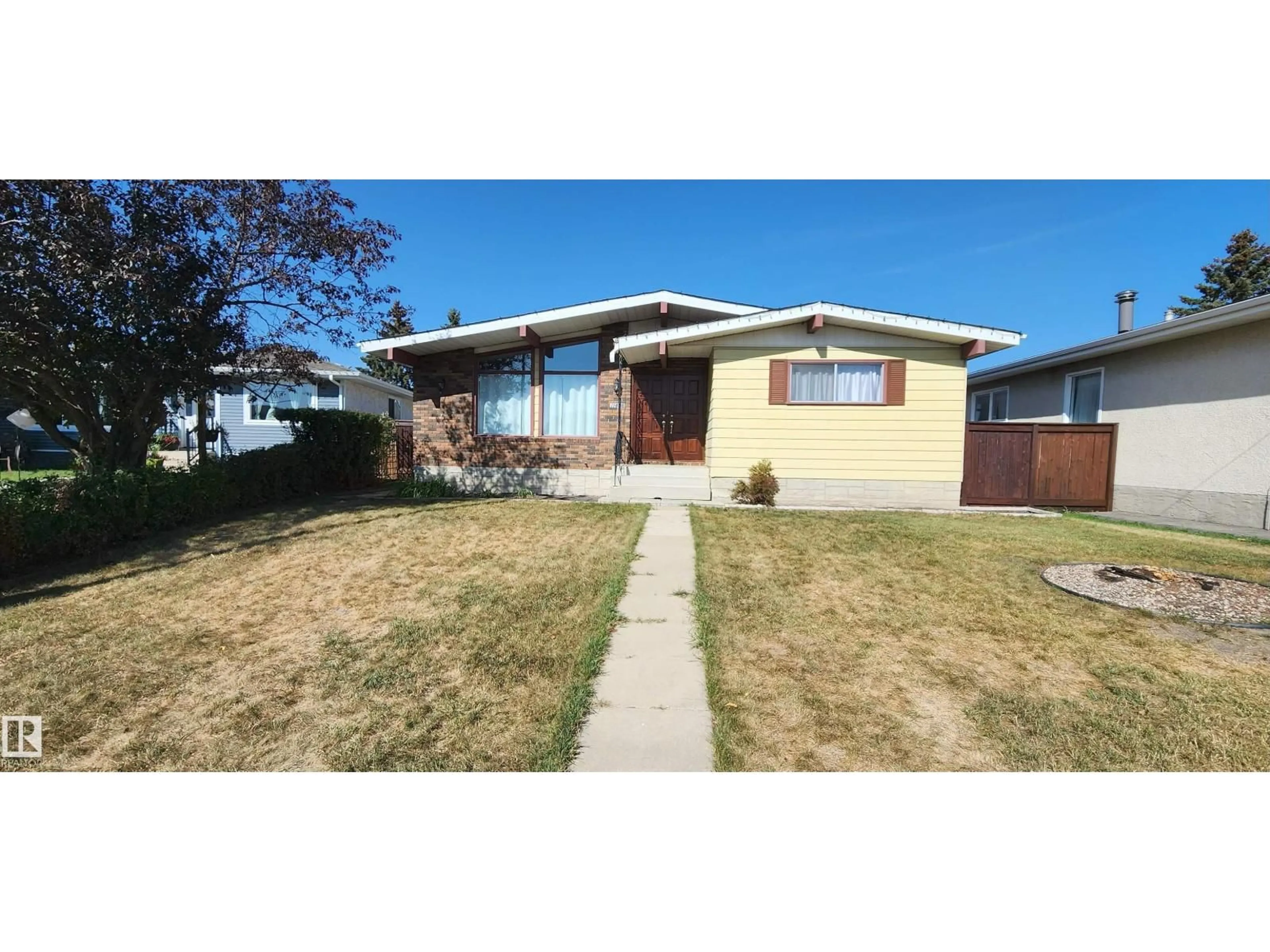 Home with vinyl exterior material, street for NW - 11436 143 AV, Edmonton Alberta T5X1L6