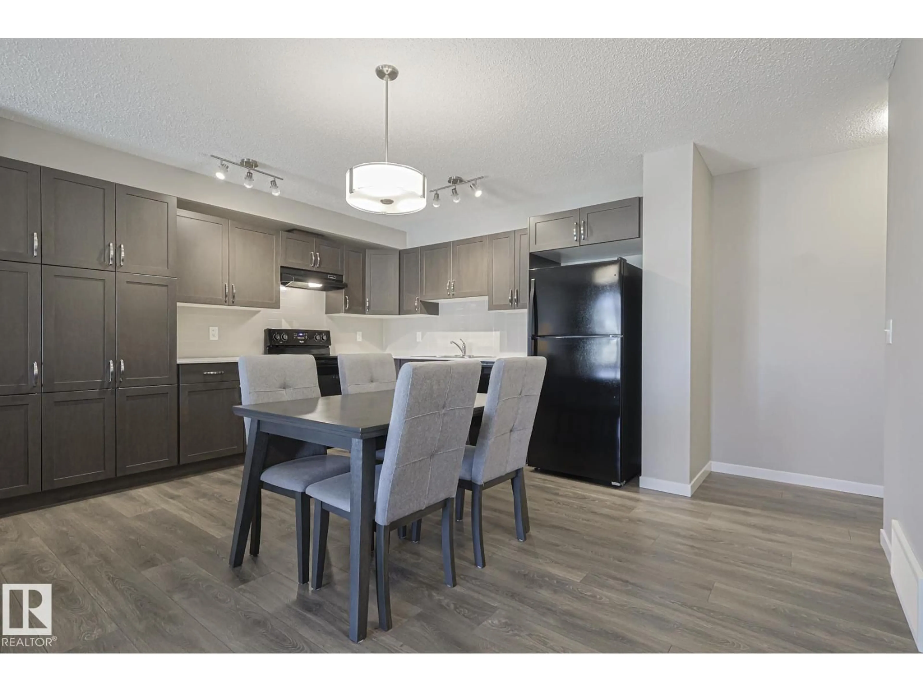 Open concept kitchen, wood/laminate floor for 17251 9 AV, Edmonton Alberta T6W3V4
