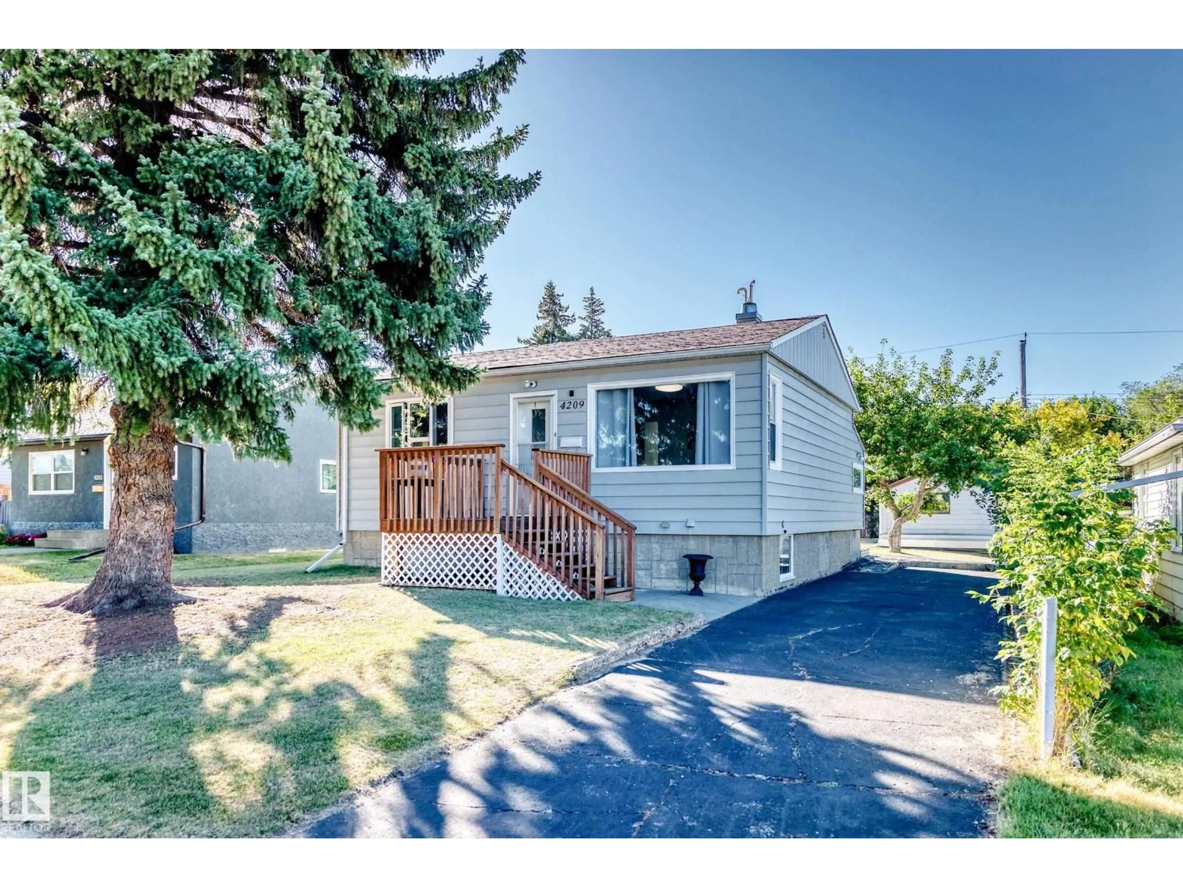 Home with vinyl exterior material, street for 4209 116 AV, Edmonton Alberta T5W0W9