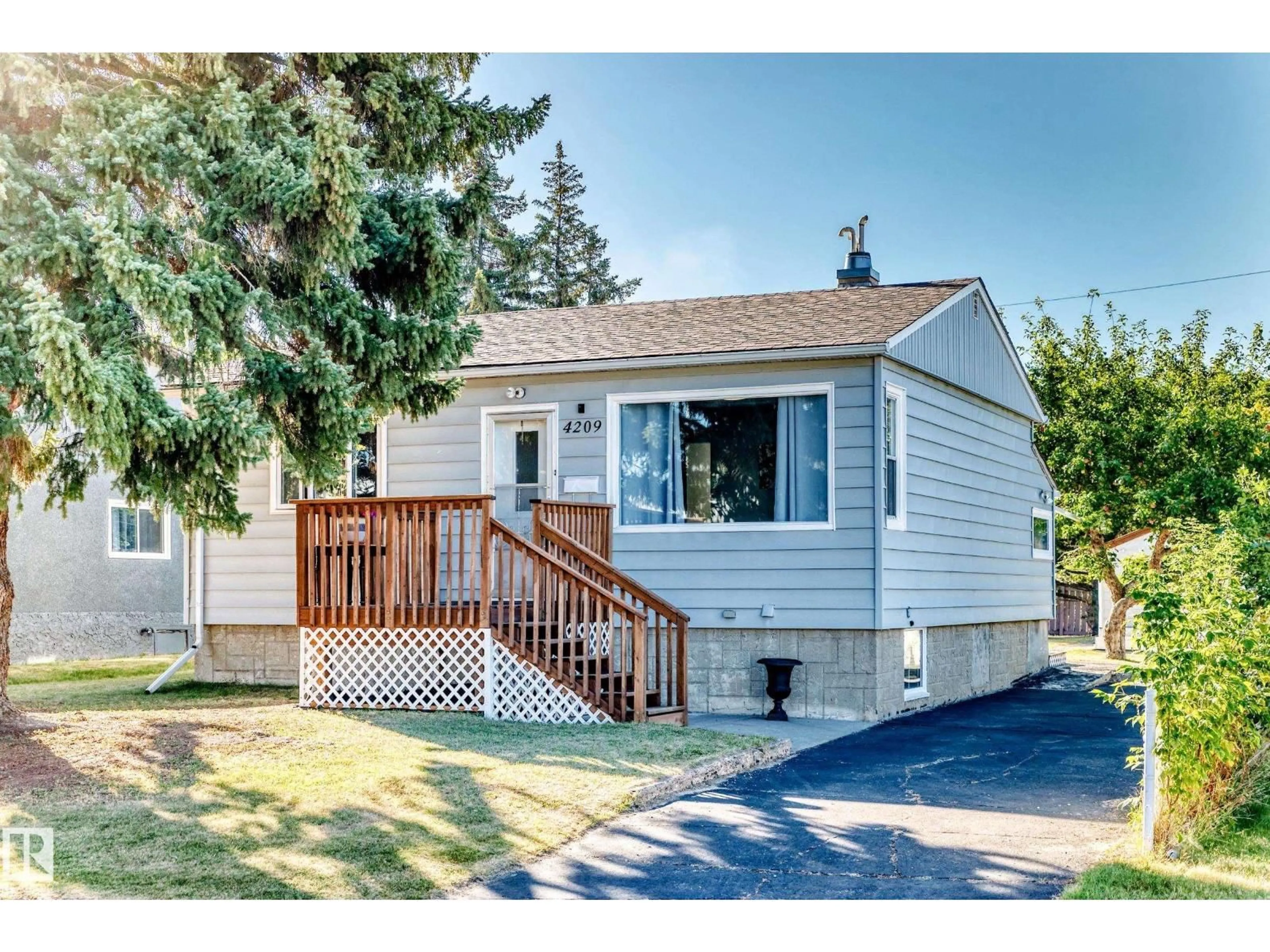 Home with vinyl exterior material, street for 4209 116 AV, Edmonton Alberta T5W0W9