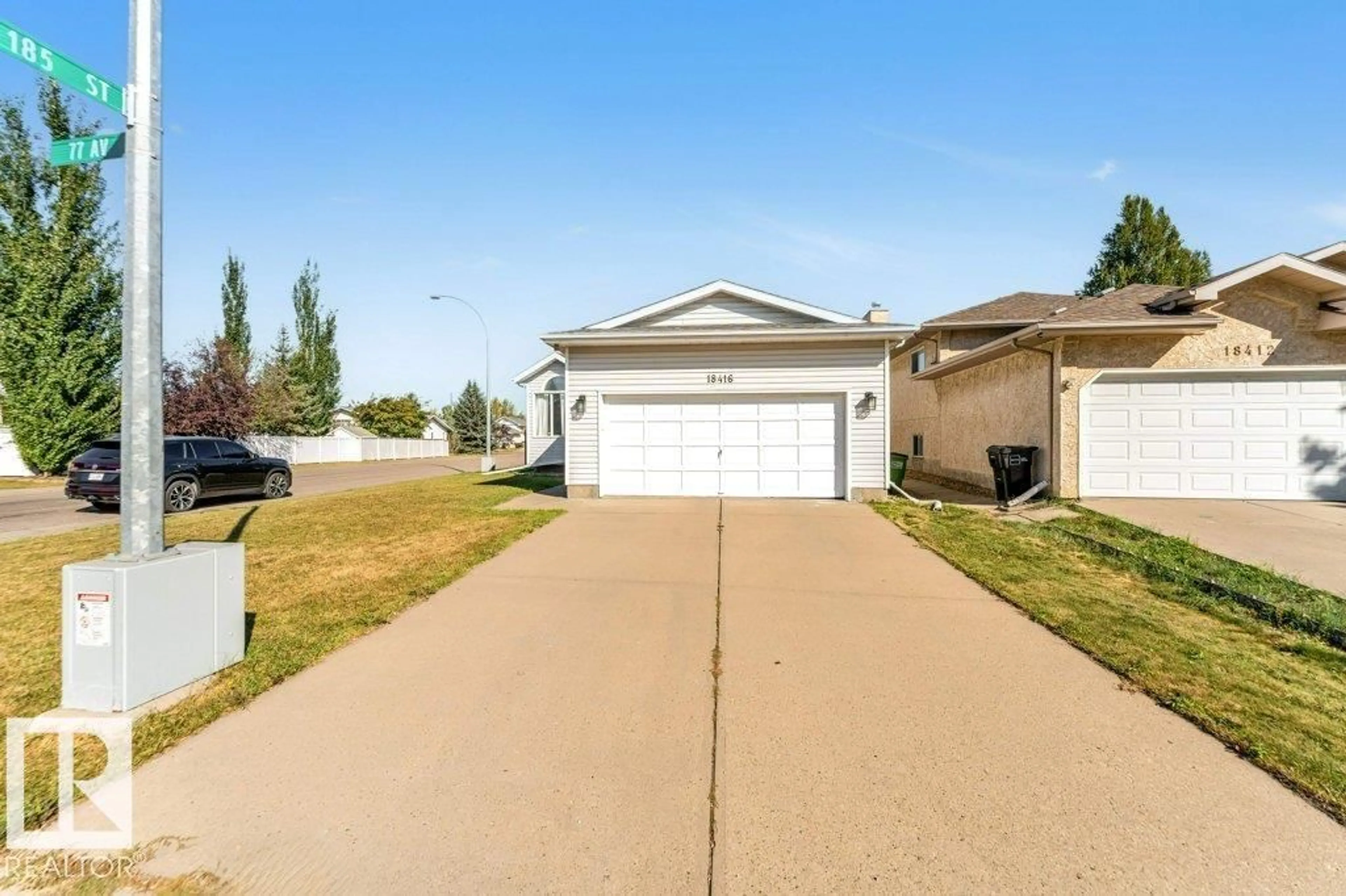 Home with vinyl exterior material, street for 18416 77 AV, Edmonton Alberta T5T5X3