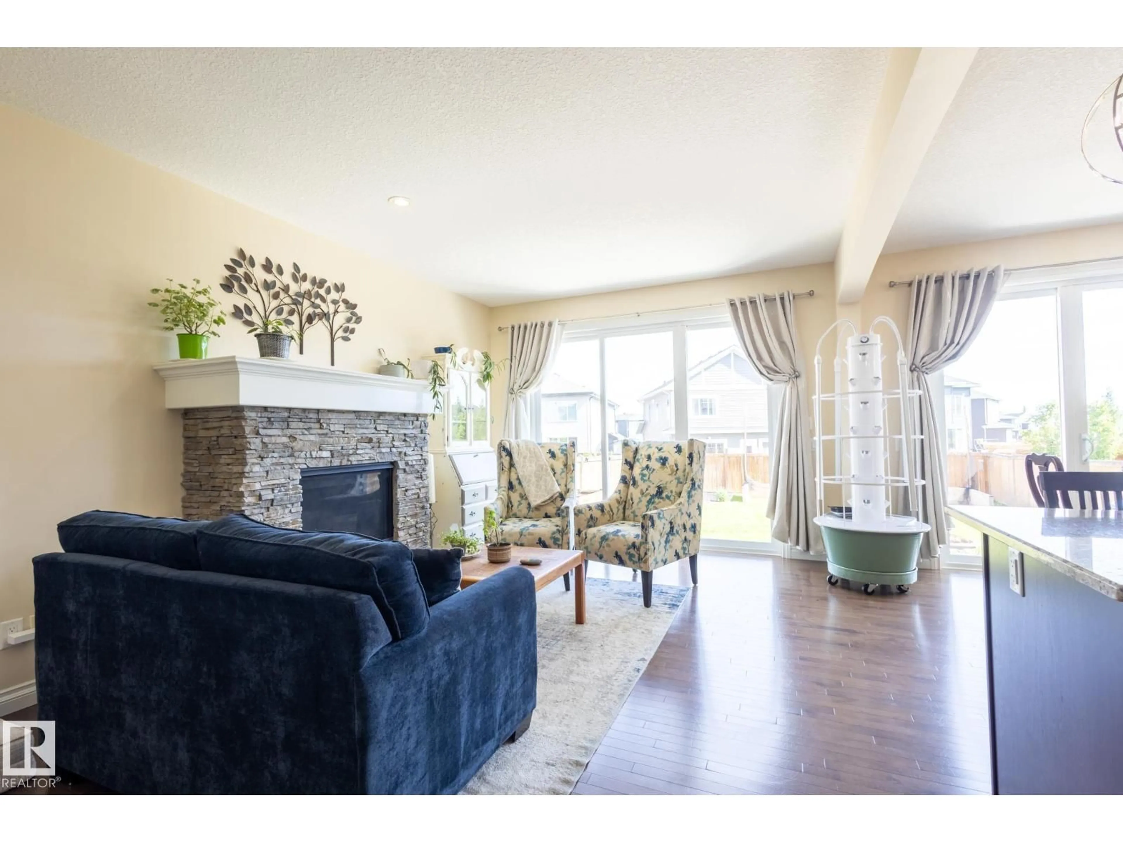 Living room with furniture, wood/laminate floor for NW - 20820 130 AV, Edmonton Alberta T5S0L4