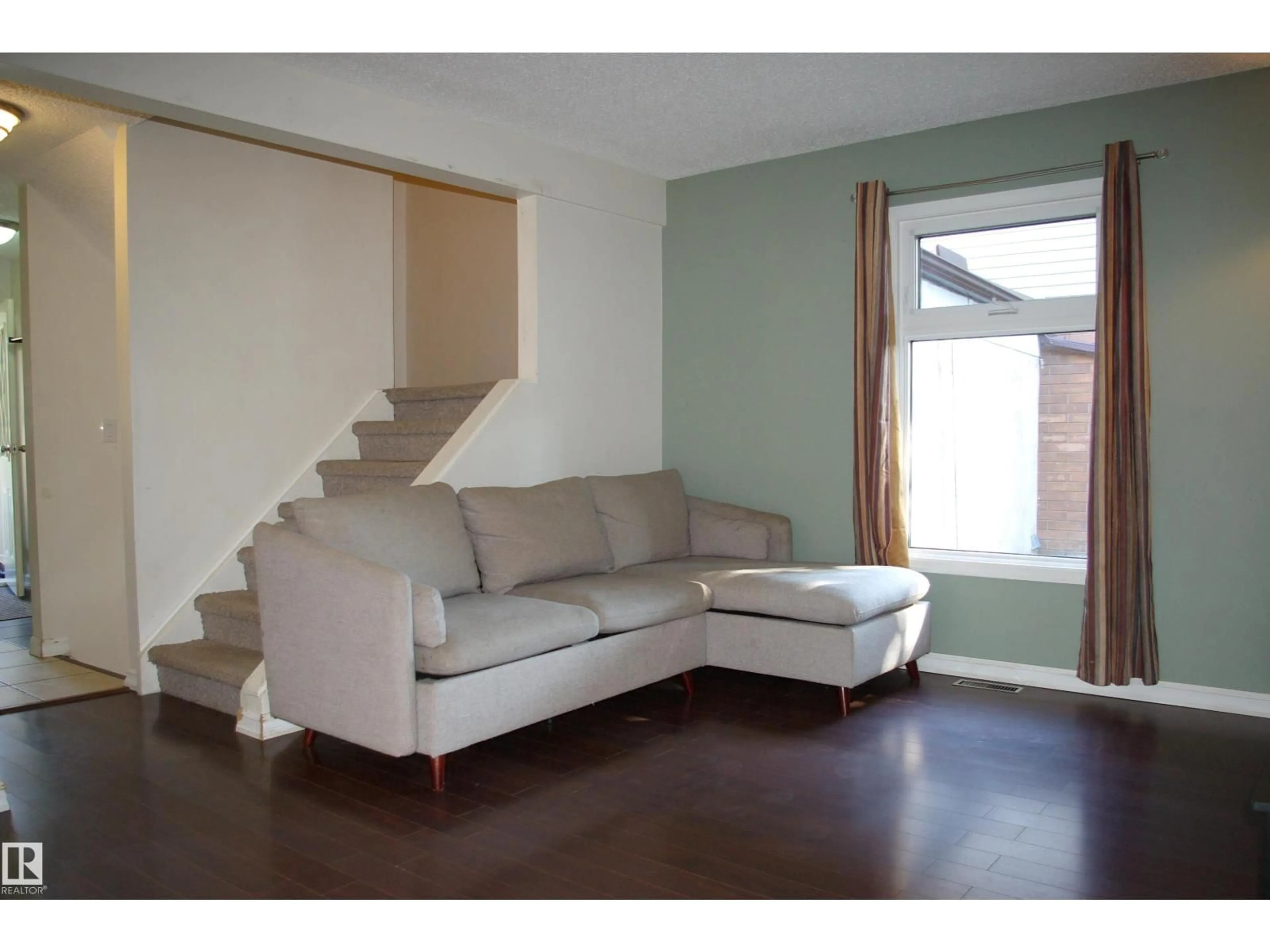 Living room with furniture, wood/laminate floor for 30 GREENFIELD ES, St. Albert Alberta T8N2G2