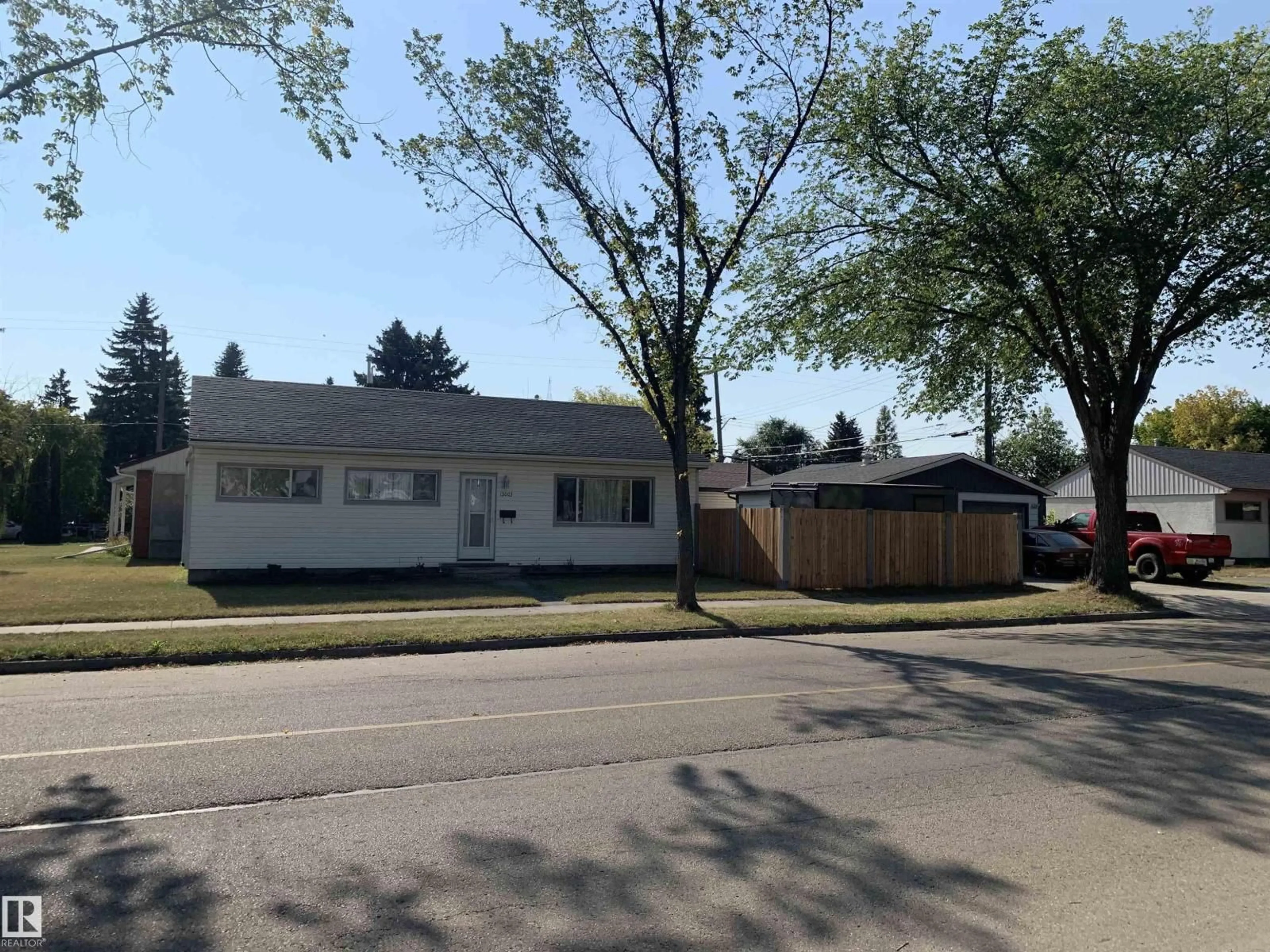 Home with vinyl exterior material, street for 13003 129 AV, Edmonton Alberta T5L3K1