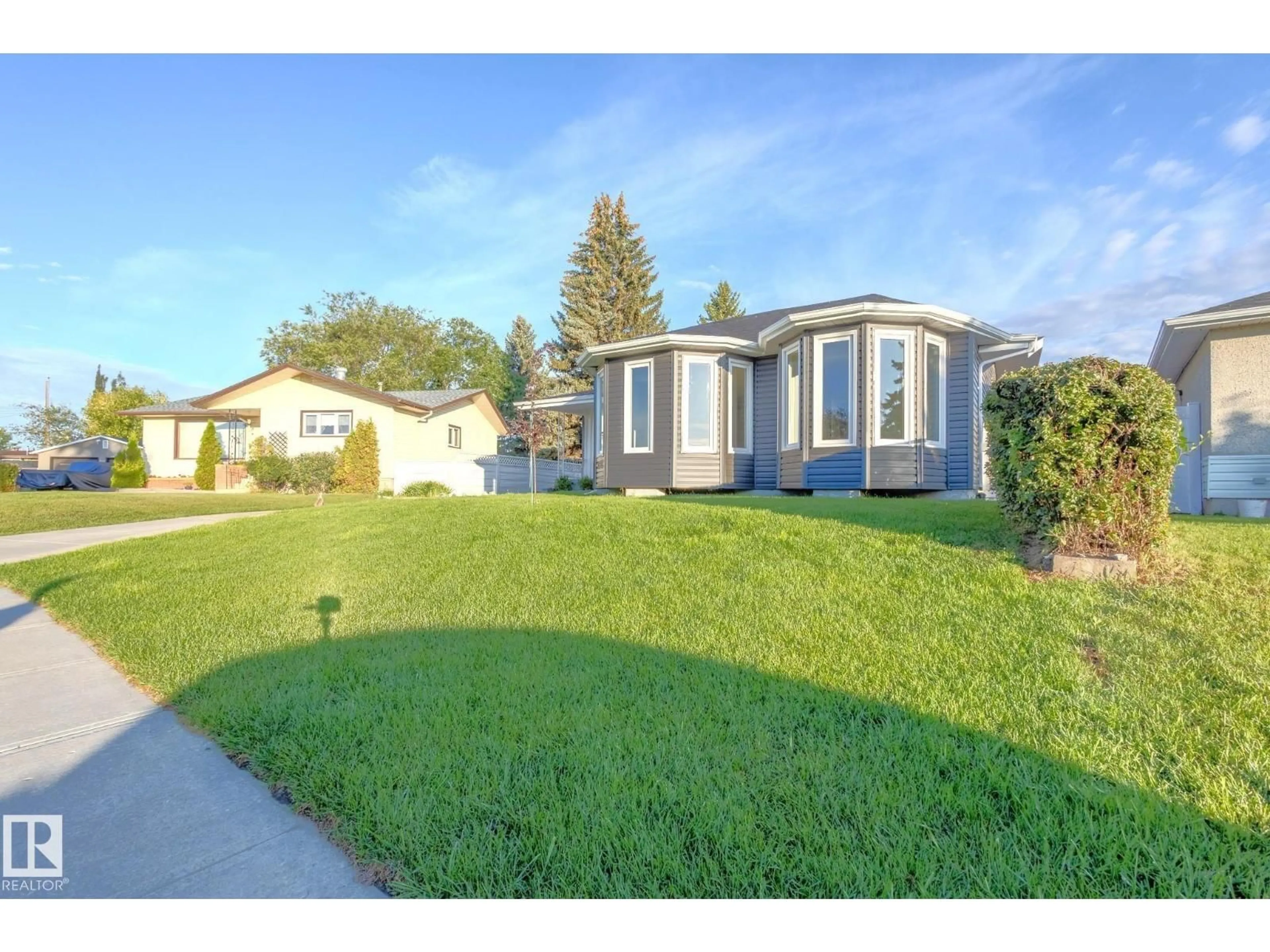 Home with vinyl exterior material, street for 10524 134 AV, Edmonton Alberta T5E1J6