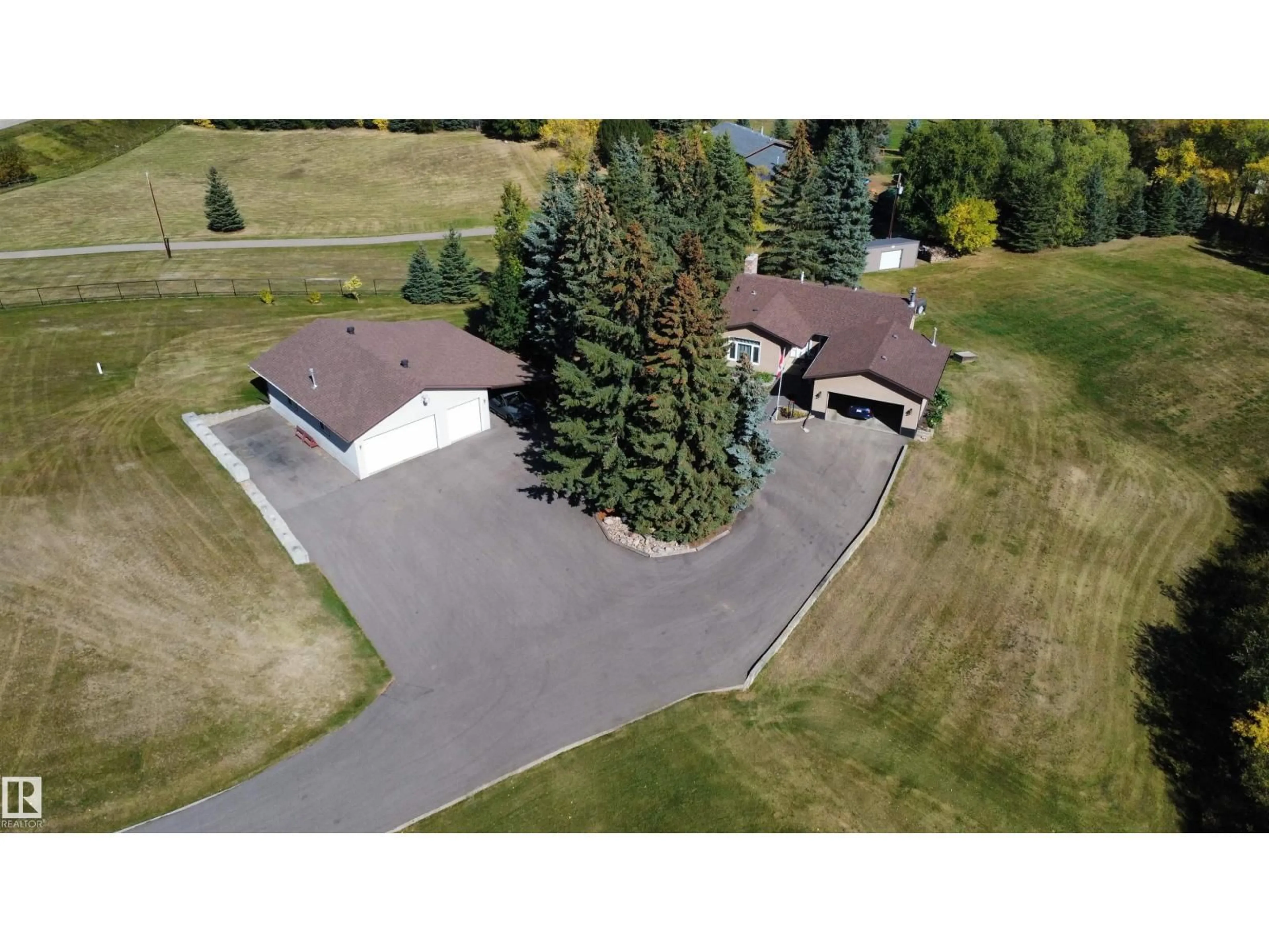 A pic from outside/outdoor area/front of a property/back of a property/a pic from drone, street for 42 - 52516 RGE ROAD 13, Rural Parkland County Alberta T7Y2C1