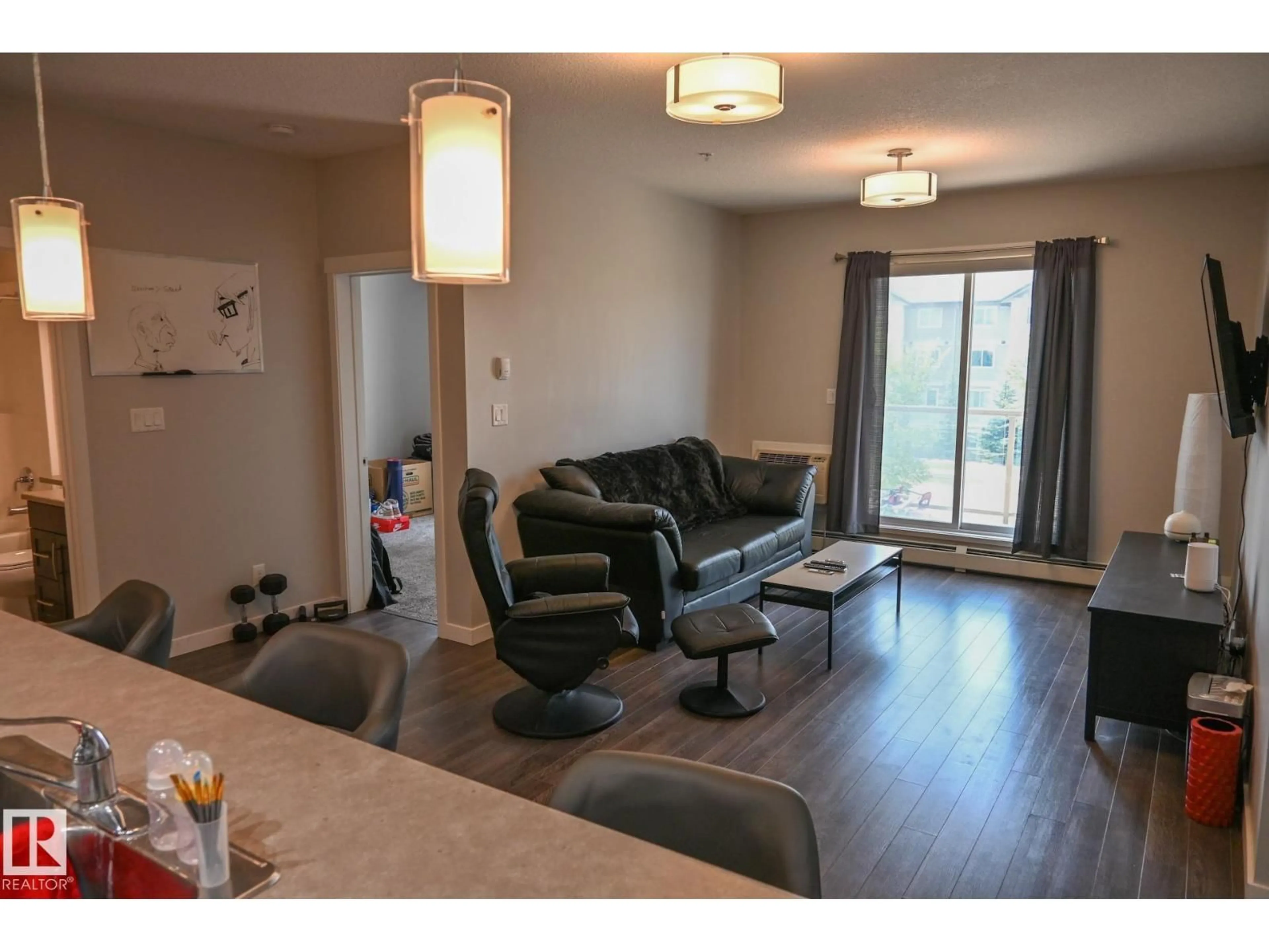 Living room with furniture, wood/laminate floor for #201 - 812 WELSH DR, Edmonton Alberta T6X1Y7