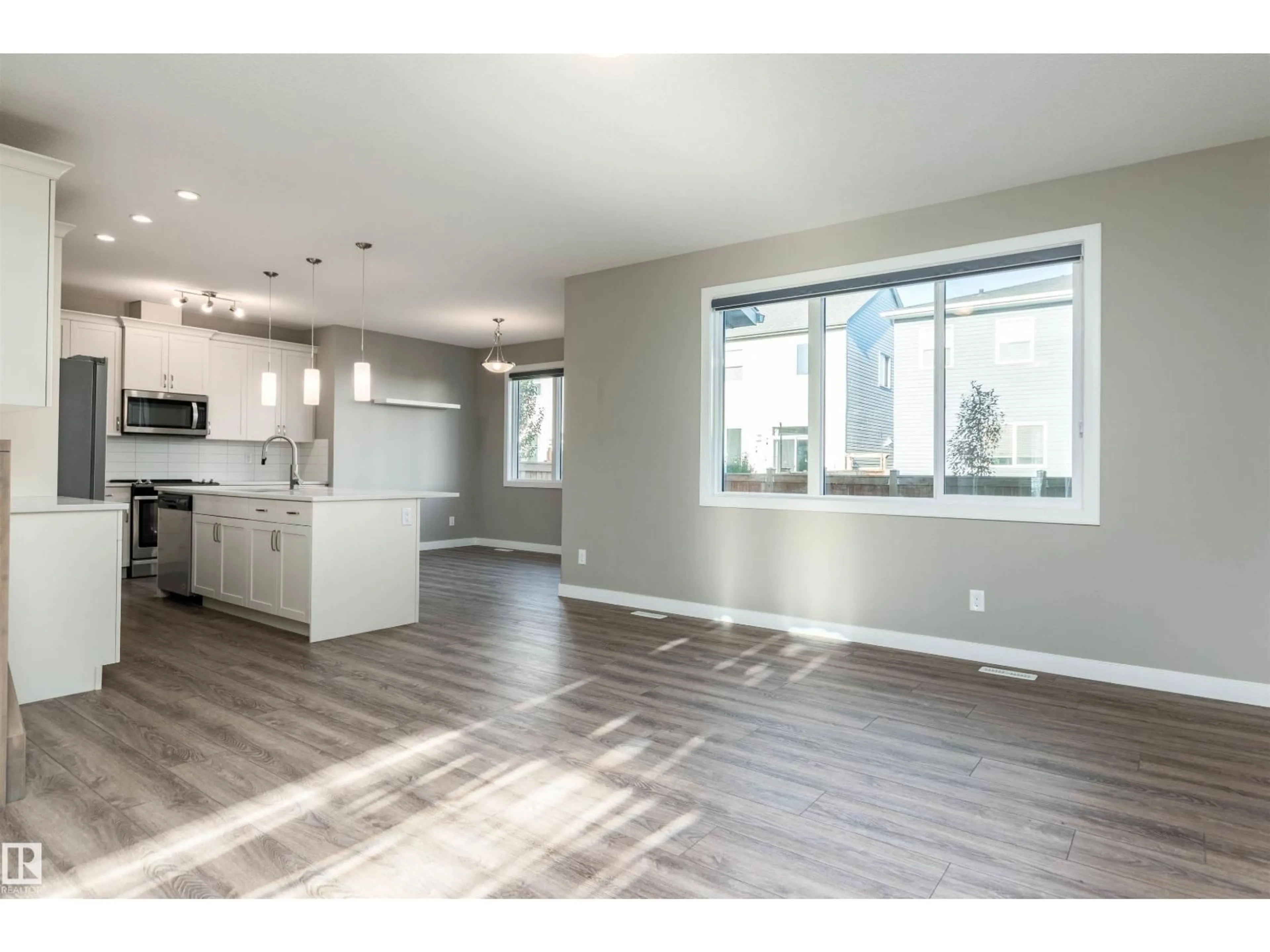 Open concept kitchen, wood/laminate floor for 1628 201 ST, Edmonton Alberta T6M0X6