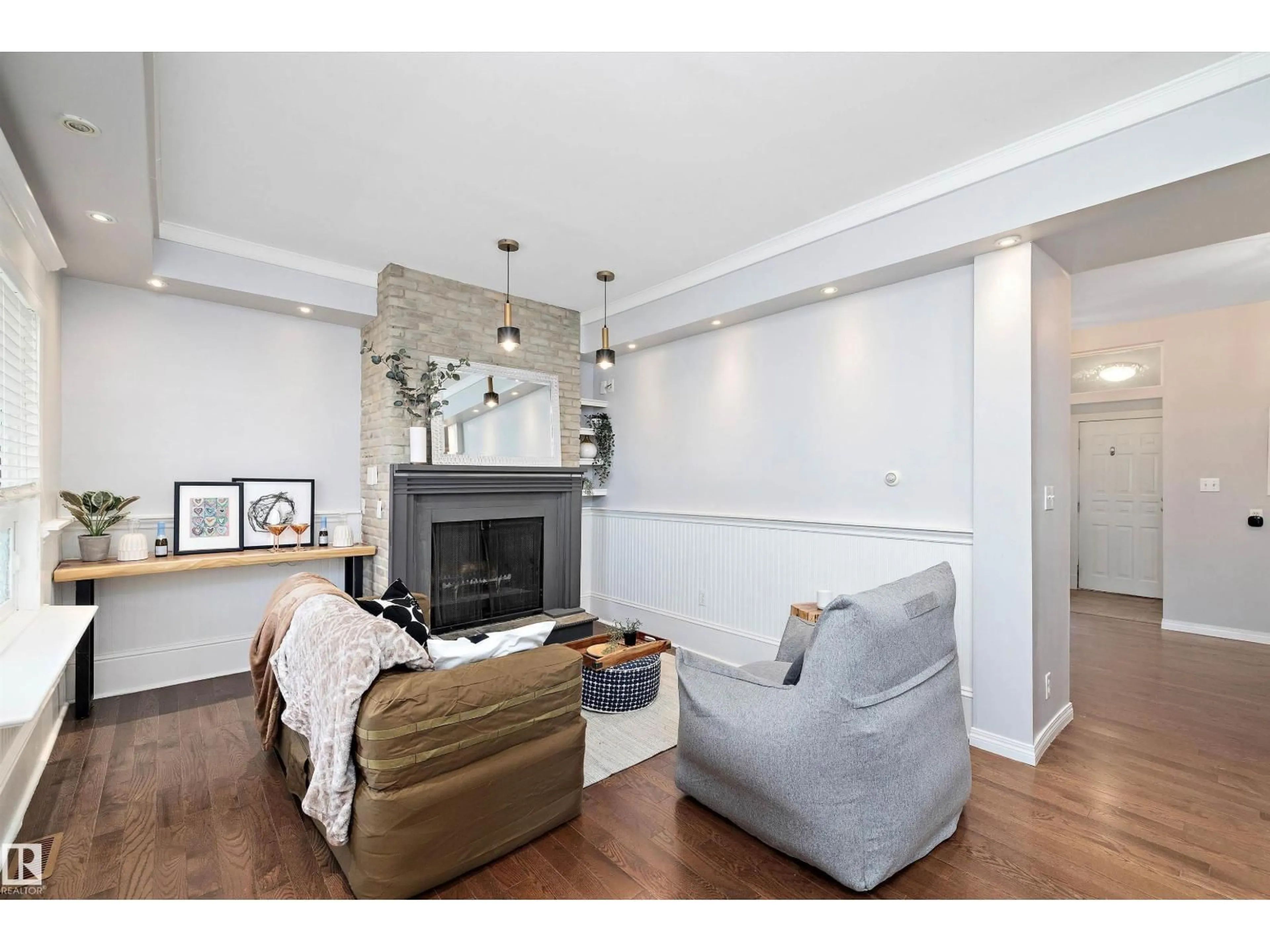 Living room with furniture, wood/laminate floor for 8702 92A AV, Edmonton Alberta T6C1S6