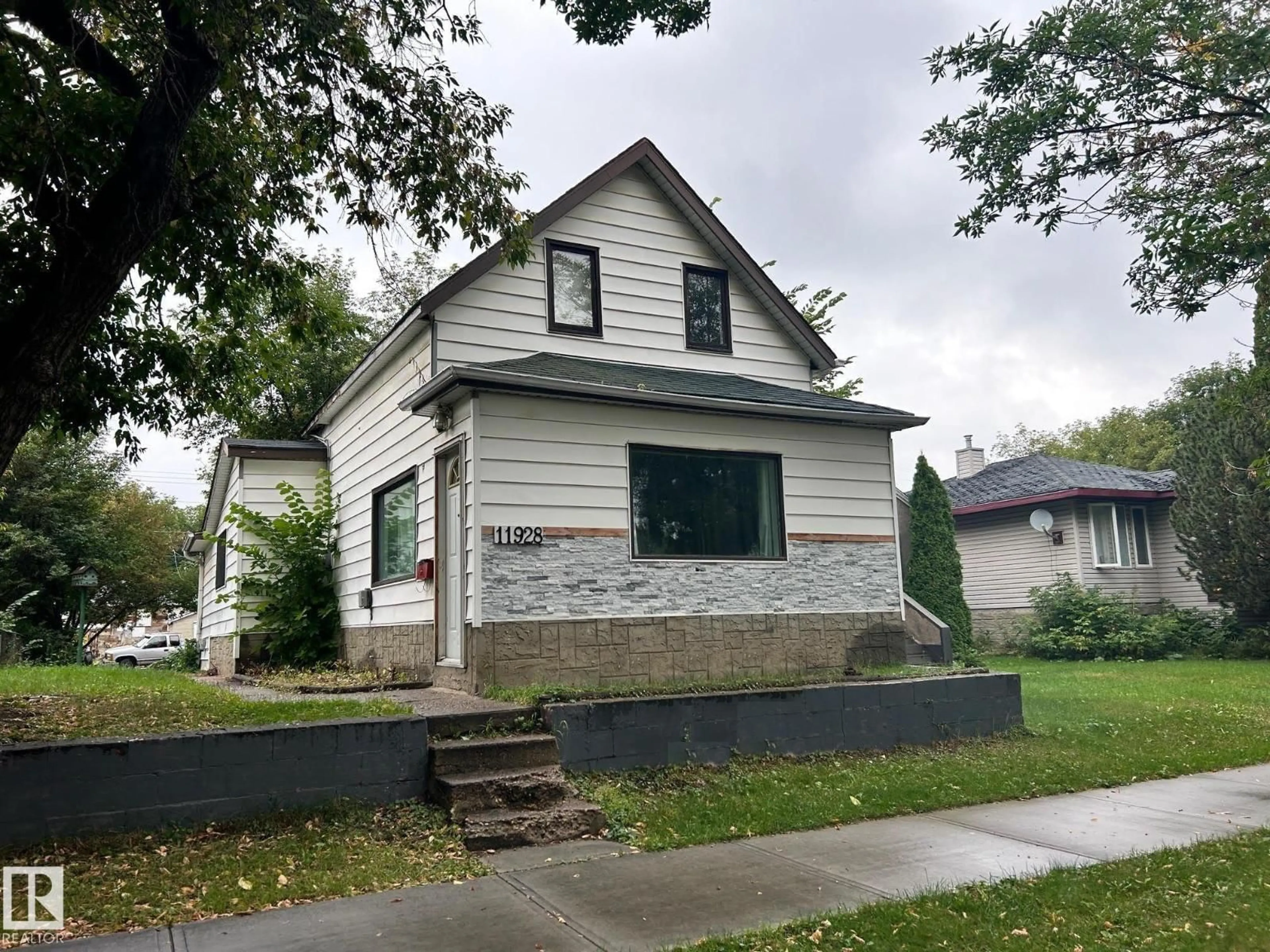 Home with vinyl exterior material, street for NW - 11928 68 ST, Edmonton Alberta T5B1P7