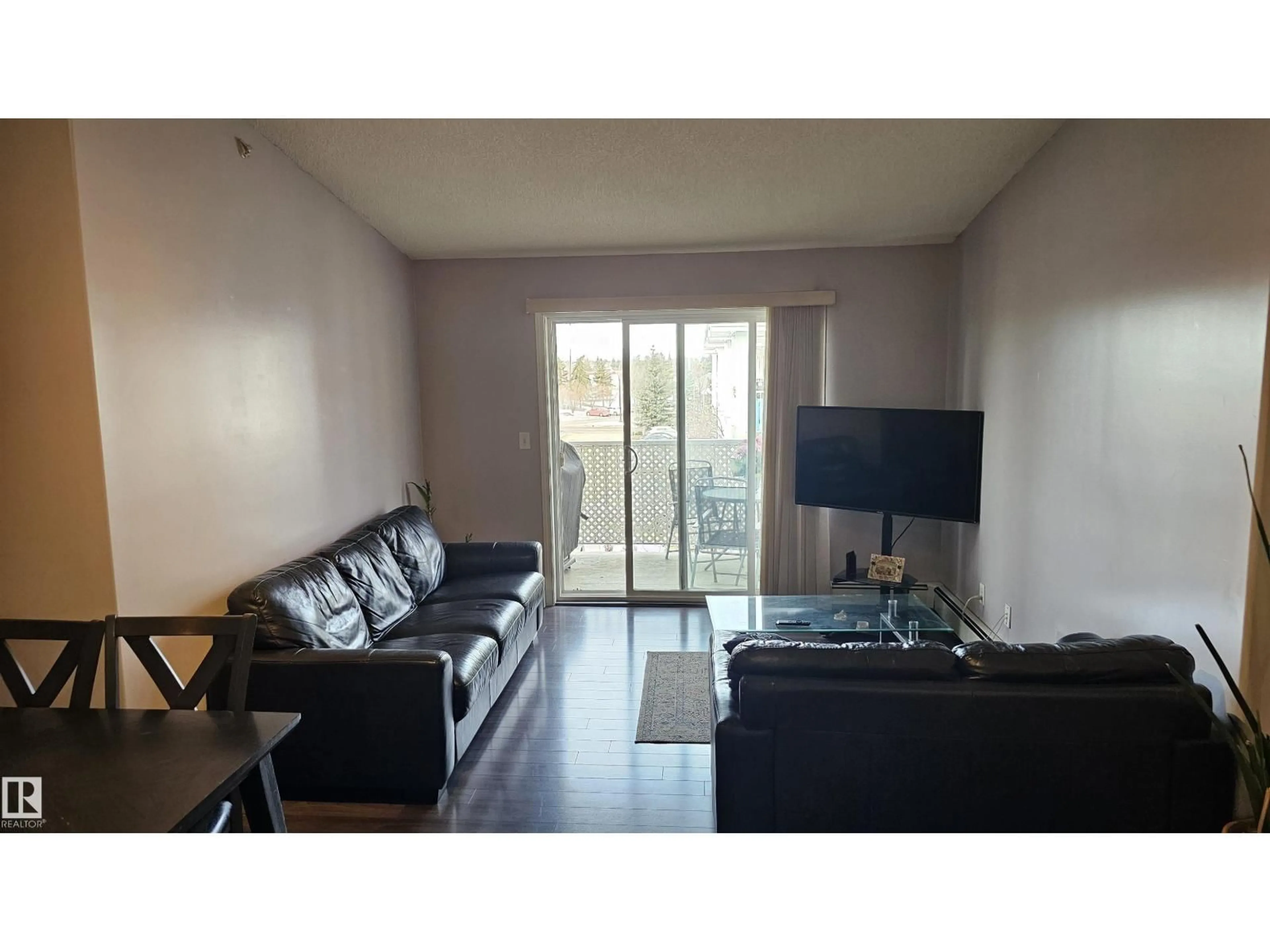 Living room with furniture, wood/laminate floor for 301 - 9525 162 AV, Edmonton Alberta T5Z3V2