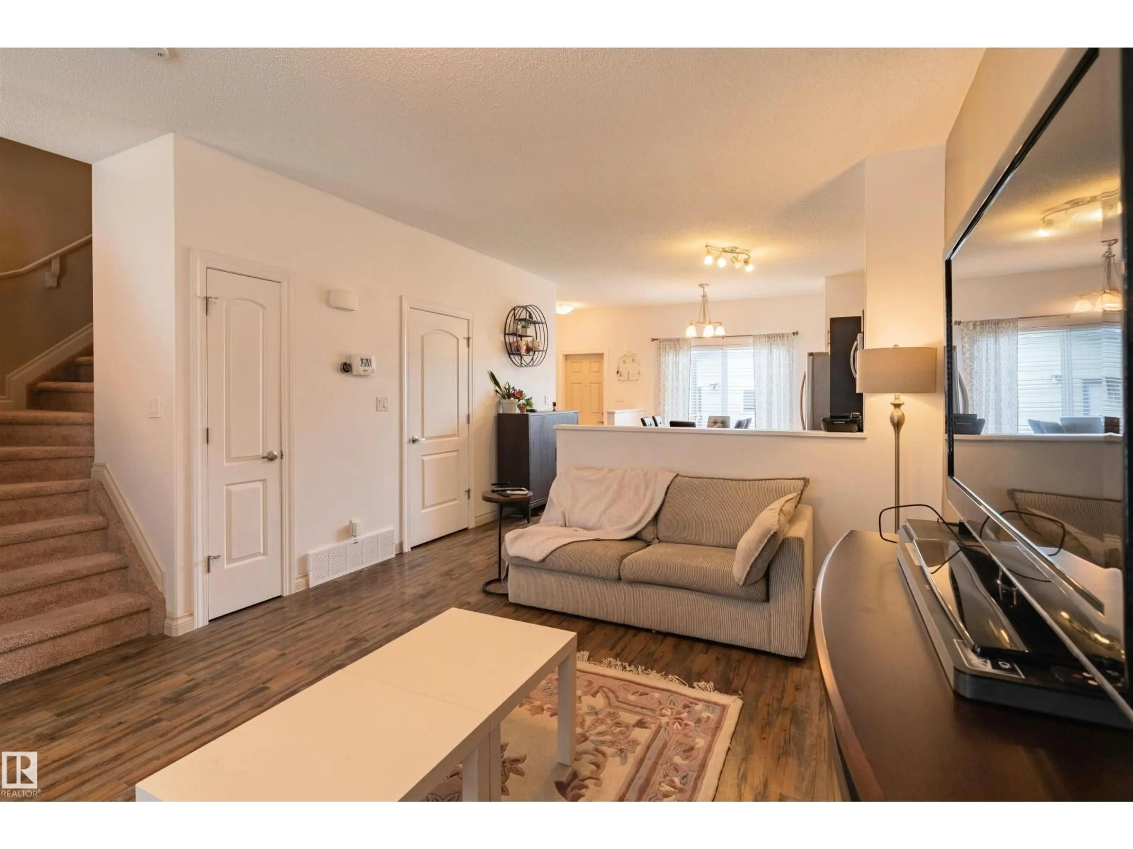 Living room with furniture, wood/laminate floor for NW - 16728 120 ST, Edmonton Alberta T5X0G5