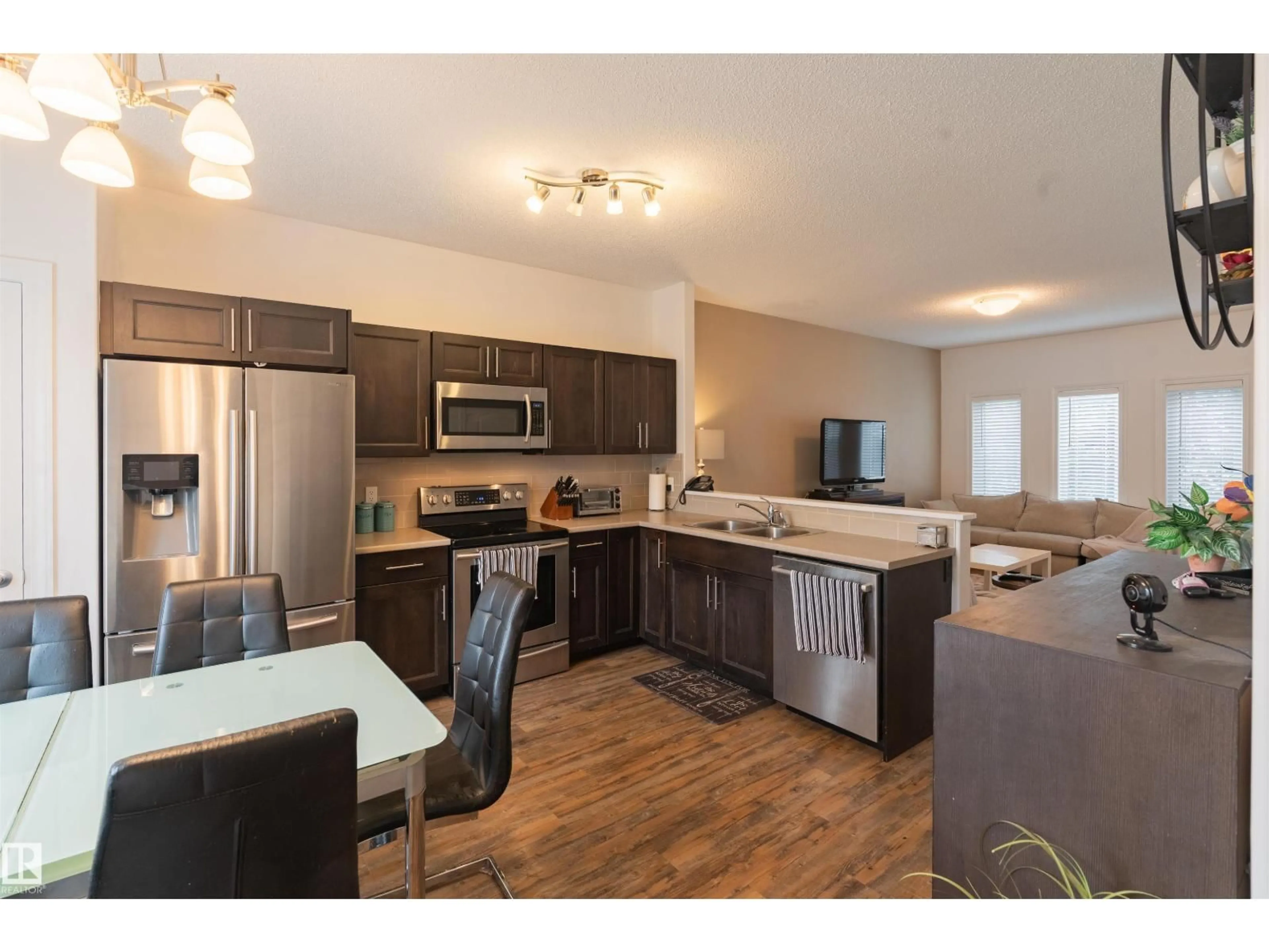 Open concept kitchen, wood/laminate floor for NW - 16728 120 ST, Edmonton Alberta T5X0G5