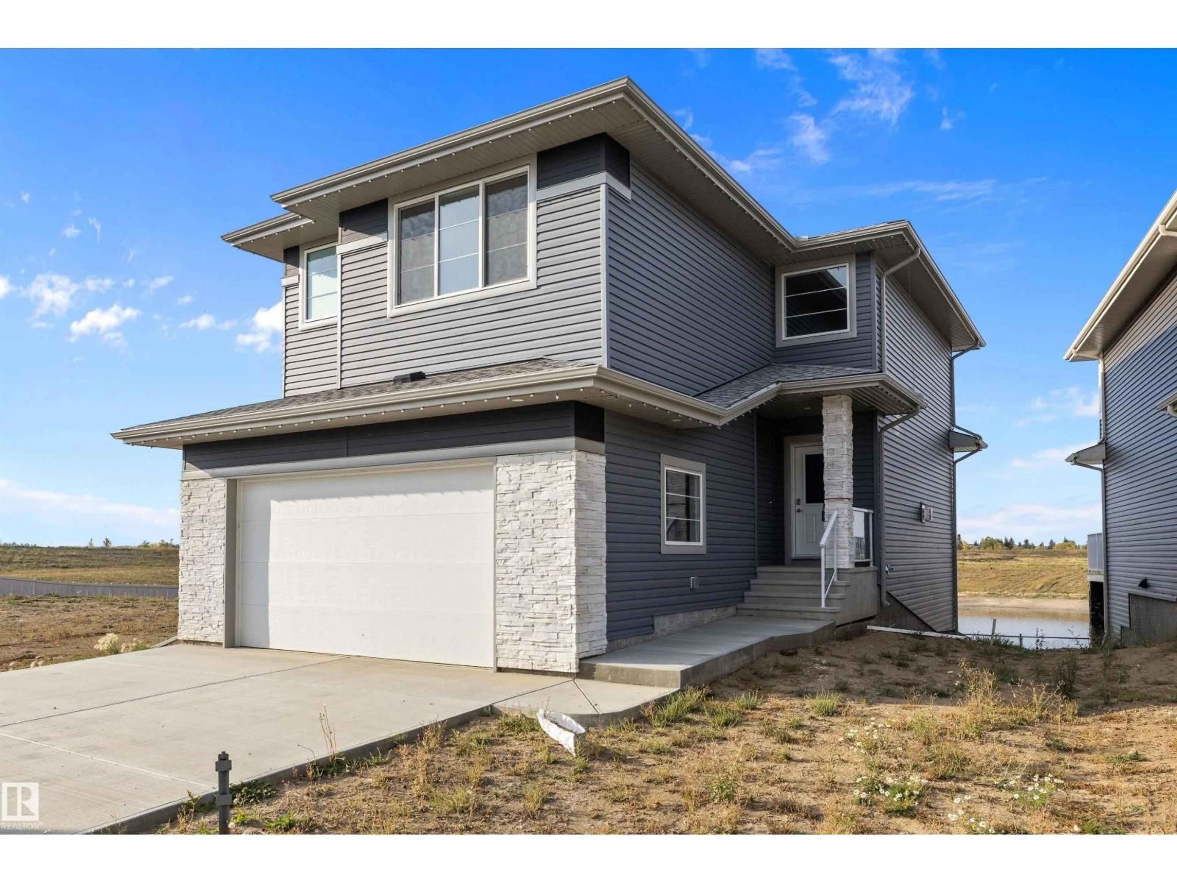 Home with vinyl exterior material, street for 10238 92A AV, Morinville Alberta T8R2R4