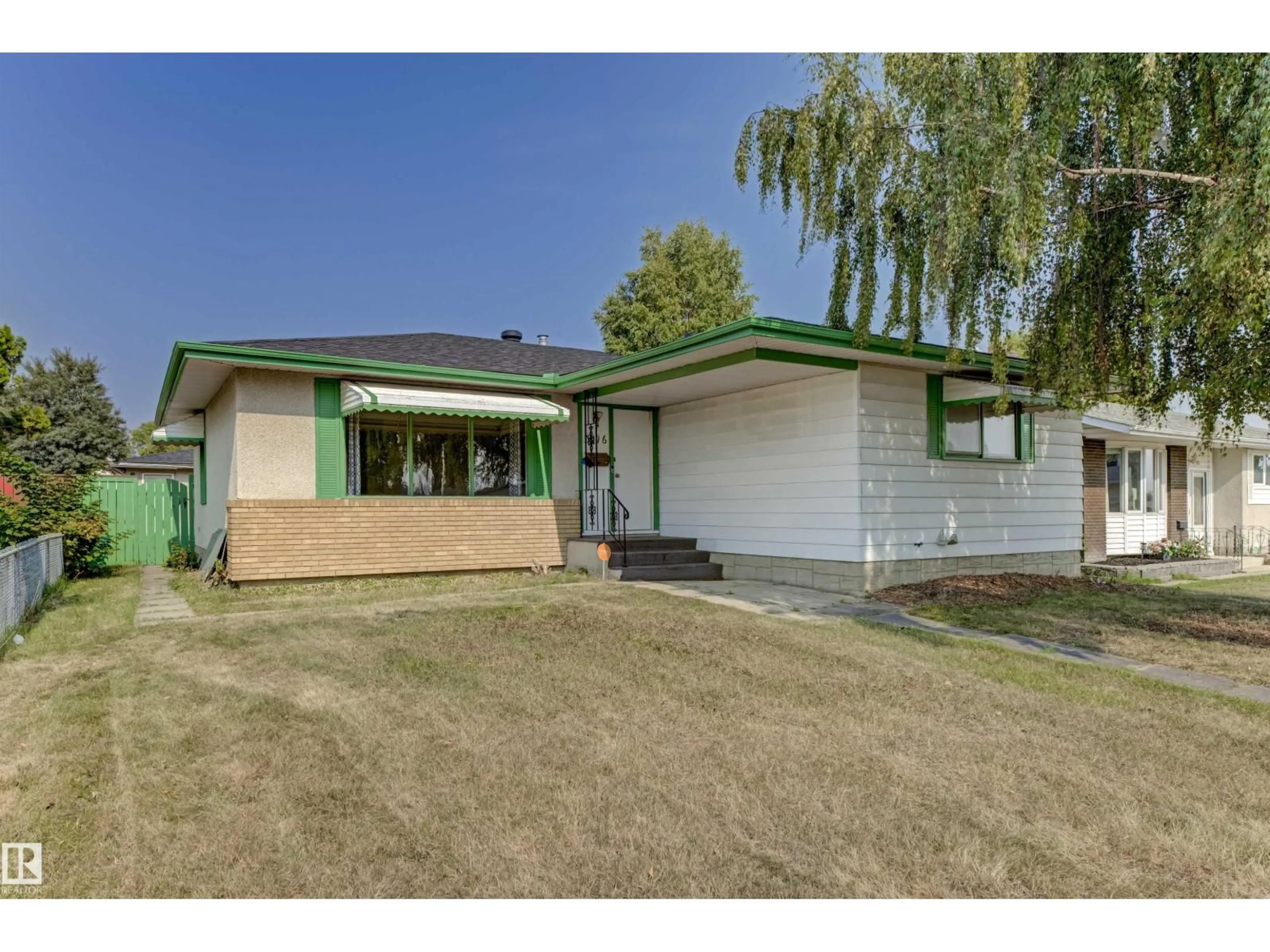 Home with vinyl exterior material, street for 3116 112 AV, Edmonton Alberta T5W0L9