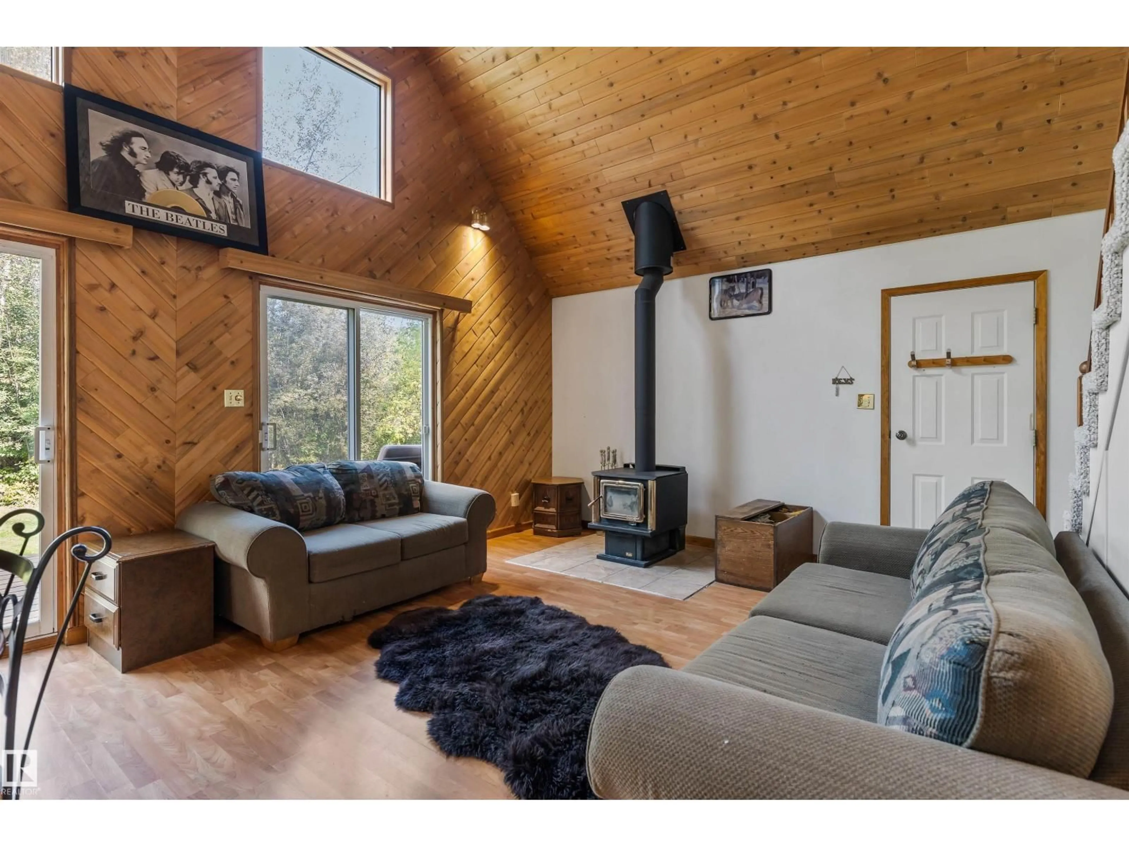 Living room with furniture, wood/laminate floor for 98 4418 HWY 633, Rural Lac Ste. Anne County Alberta T0E0L0