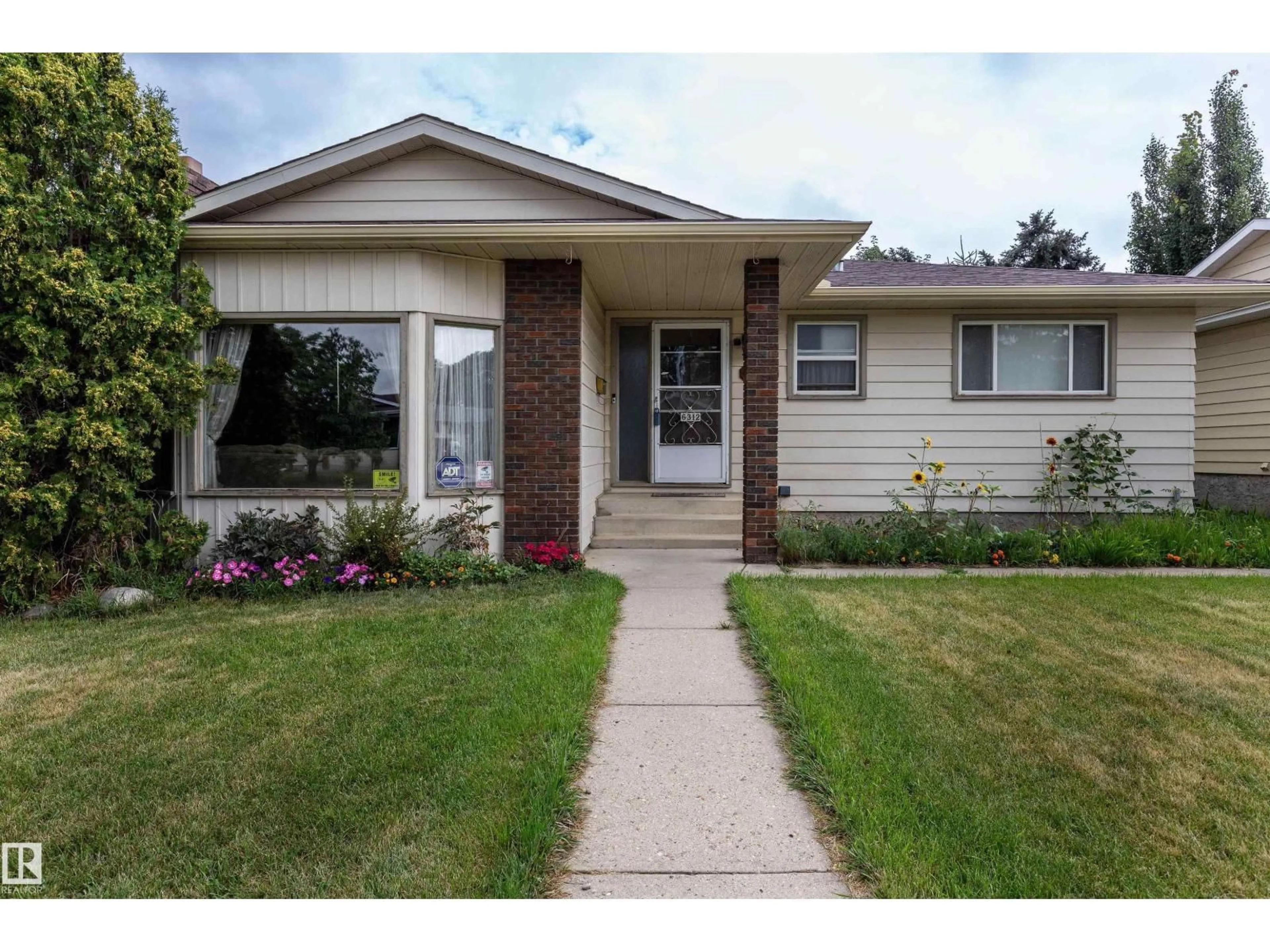 Home with vinyl exterior material, street for 6312 17 AV, Edmonton Alberta T6L1N4