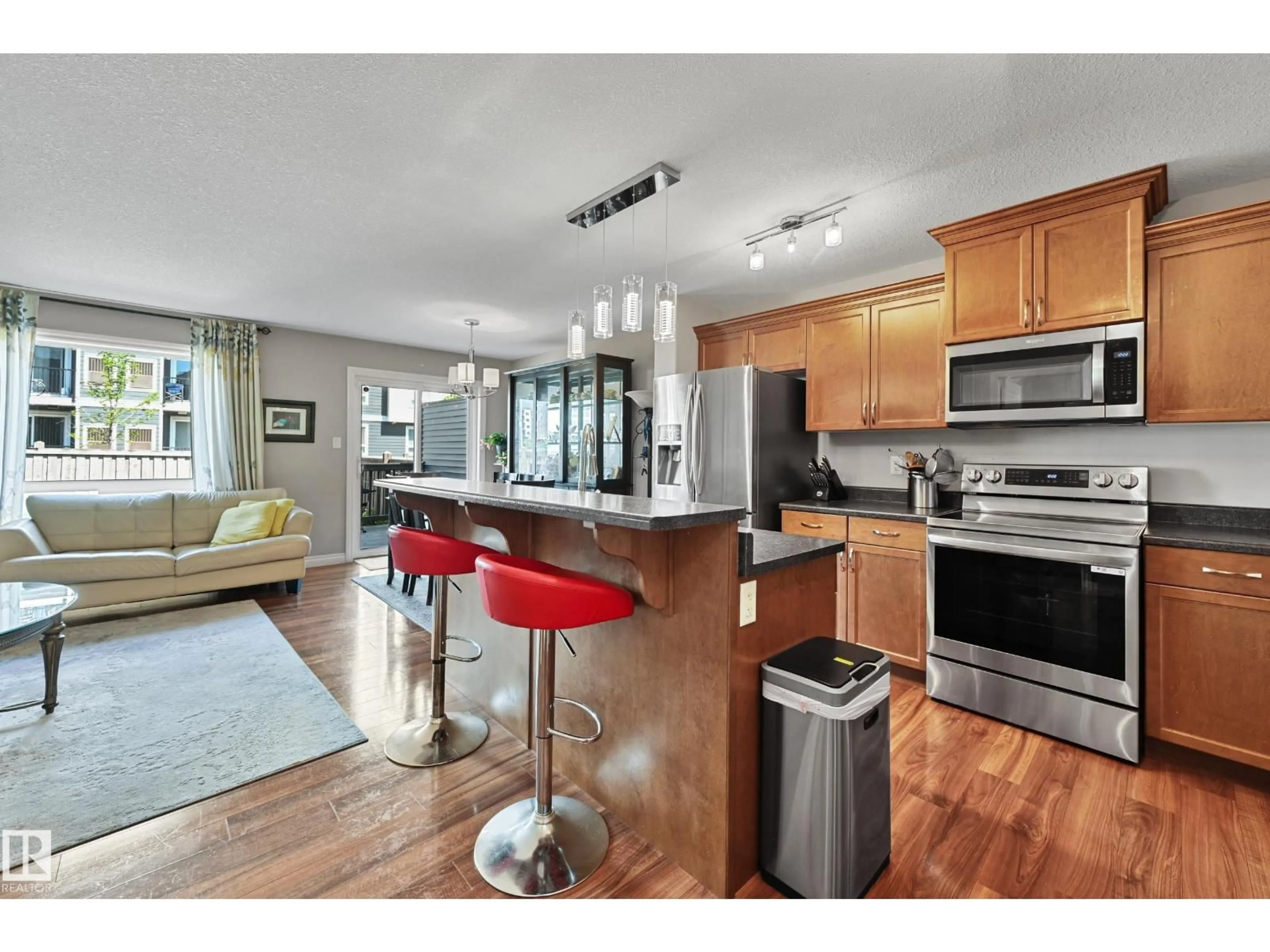 Open concept kitchen, wood/laminate floor for 21914 91 AV, Edmonton Alberta T5T6Z5