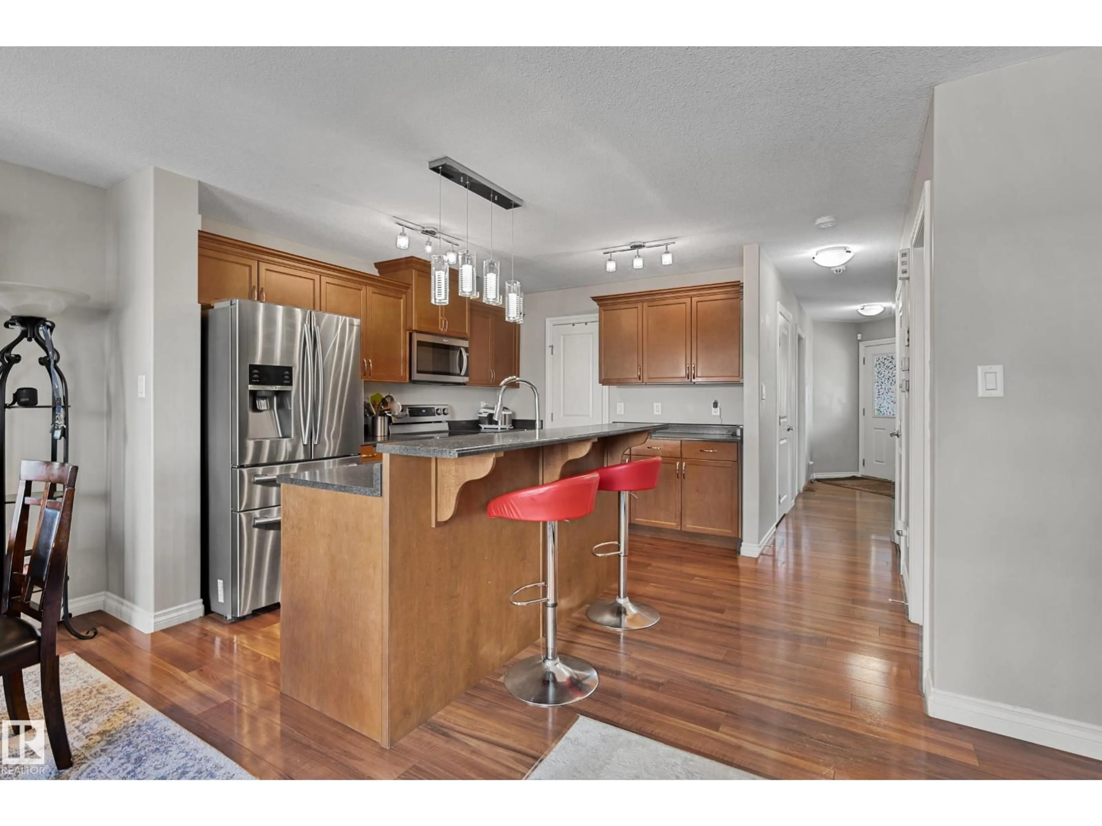 Open concept kitchen, wood/laminate floor for 21914 91 AV, Edmonton Alberta T5T6Z5