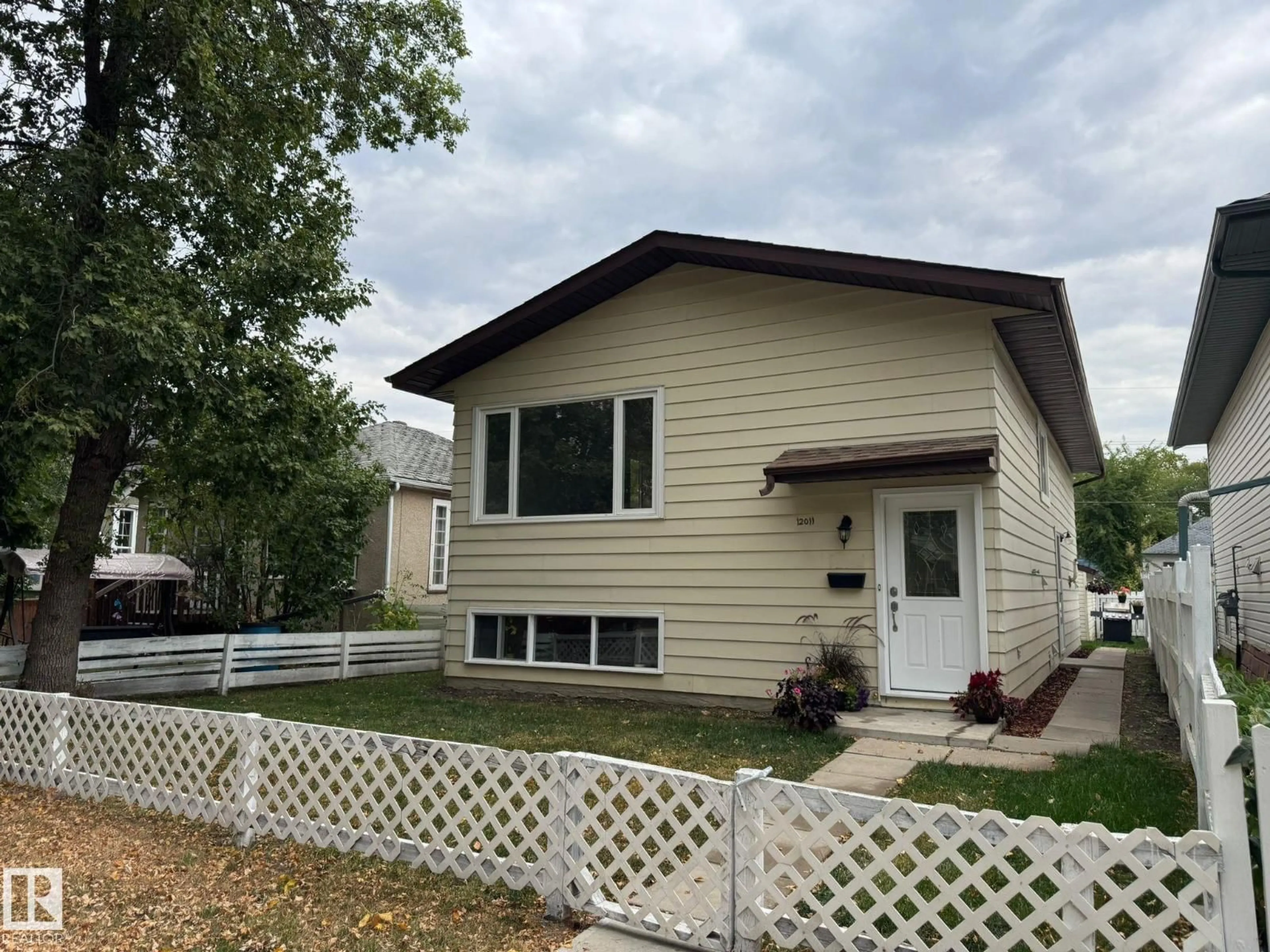 Home with vinyl exterior material, street for 12011 95A ST NW, Edmonton Alberta T5G1R6