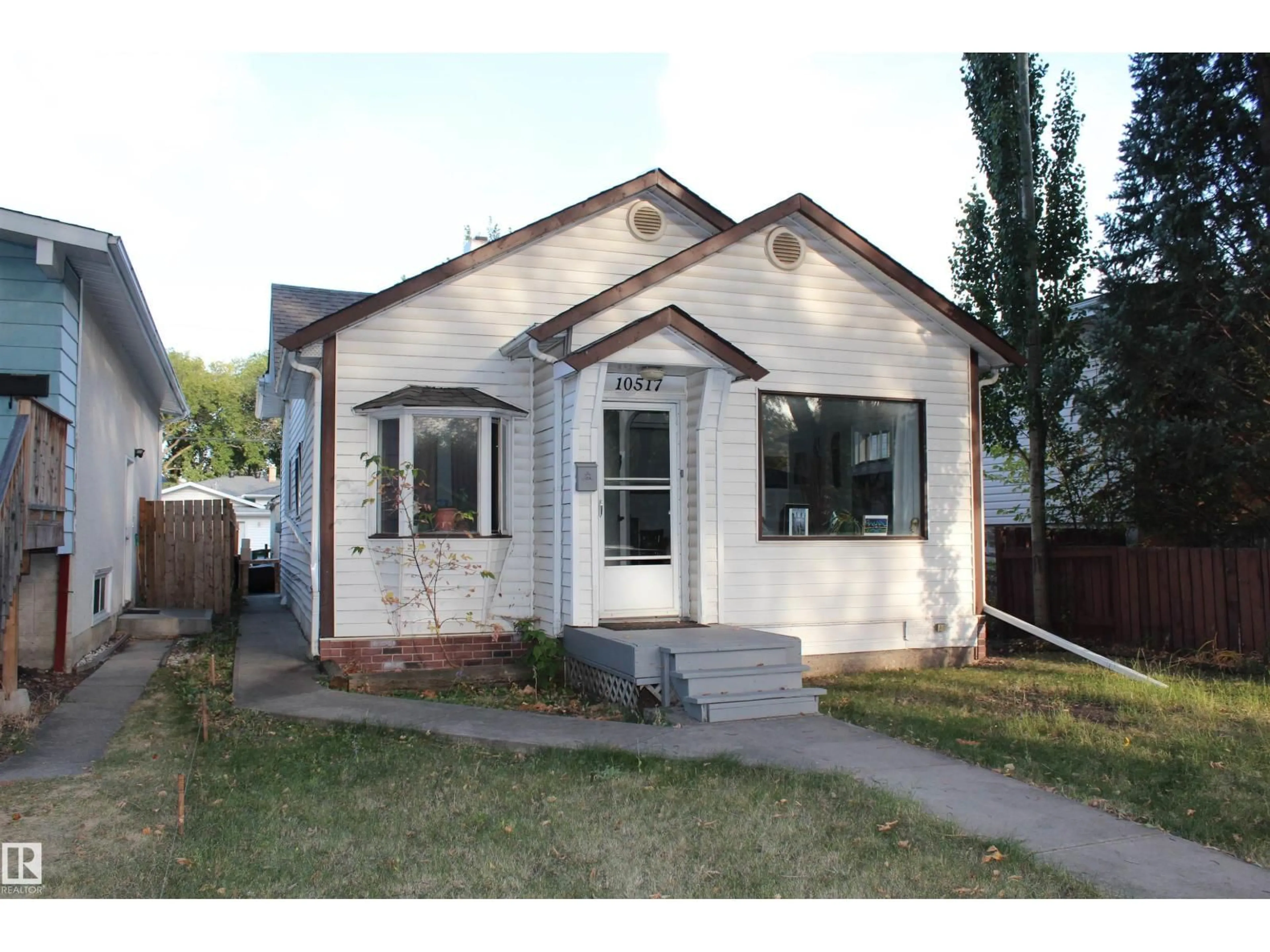 Home with vinyl exterior material, street for 10517 82 ST, Edmonton Alberta T6A3M9