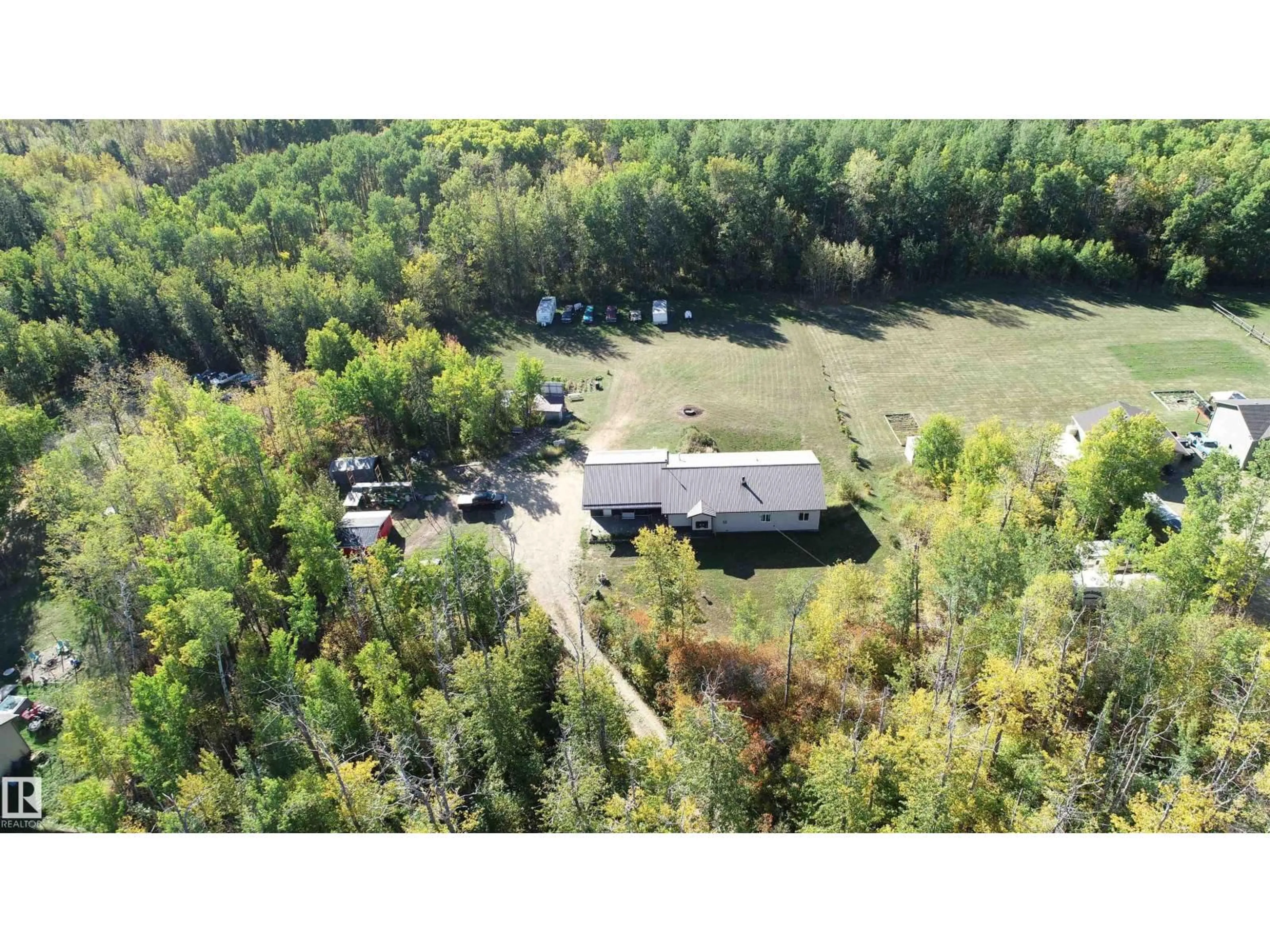 A pic from outside/outdoor area/front of a property/back of a property/a pic from drone, forest/trees view for 207 - 55108 RGE ROAD 15, Rural Lac Ste. Anne County Alberta T0E1V0