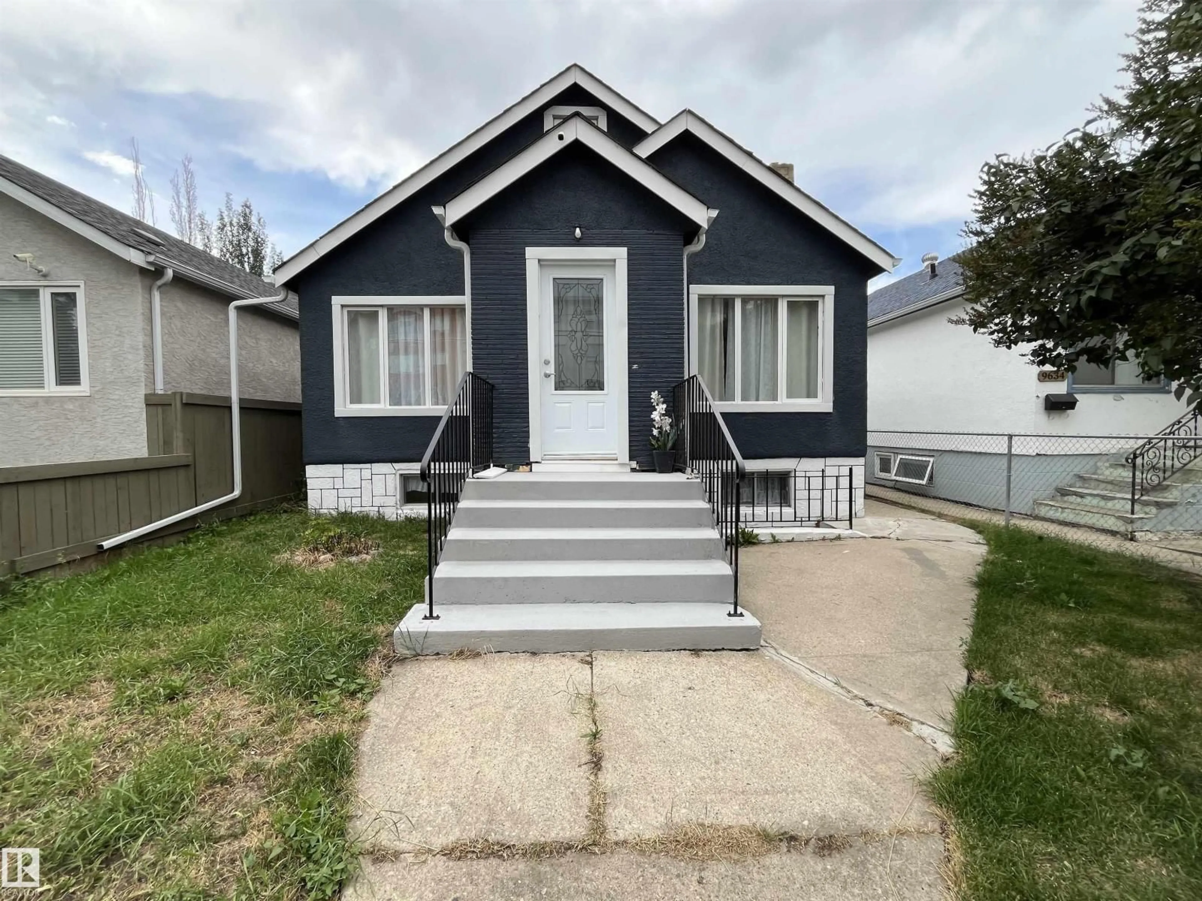 Home with vinyl exterior material, street for 9638 106 AV, Edmonton Alberta T5H0N4