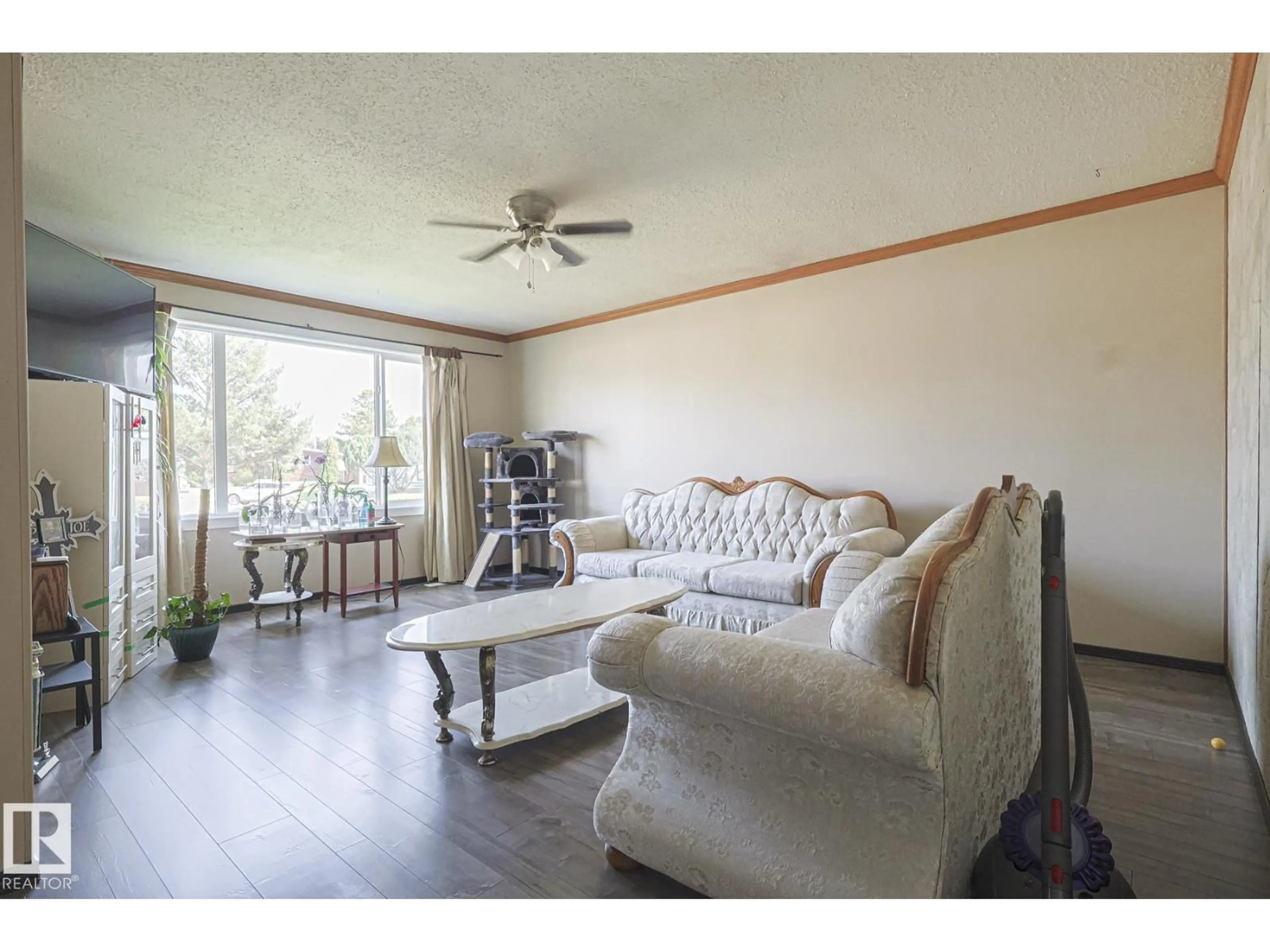 Living room with furniture, wood/laminate floor for 128 CAMELOT AV, Leduc Alberta T9E4L1