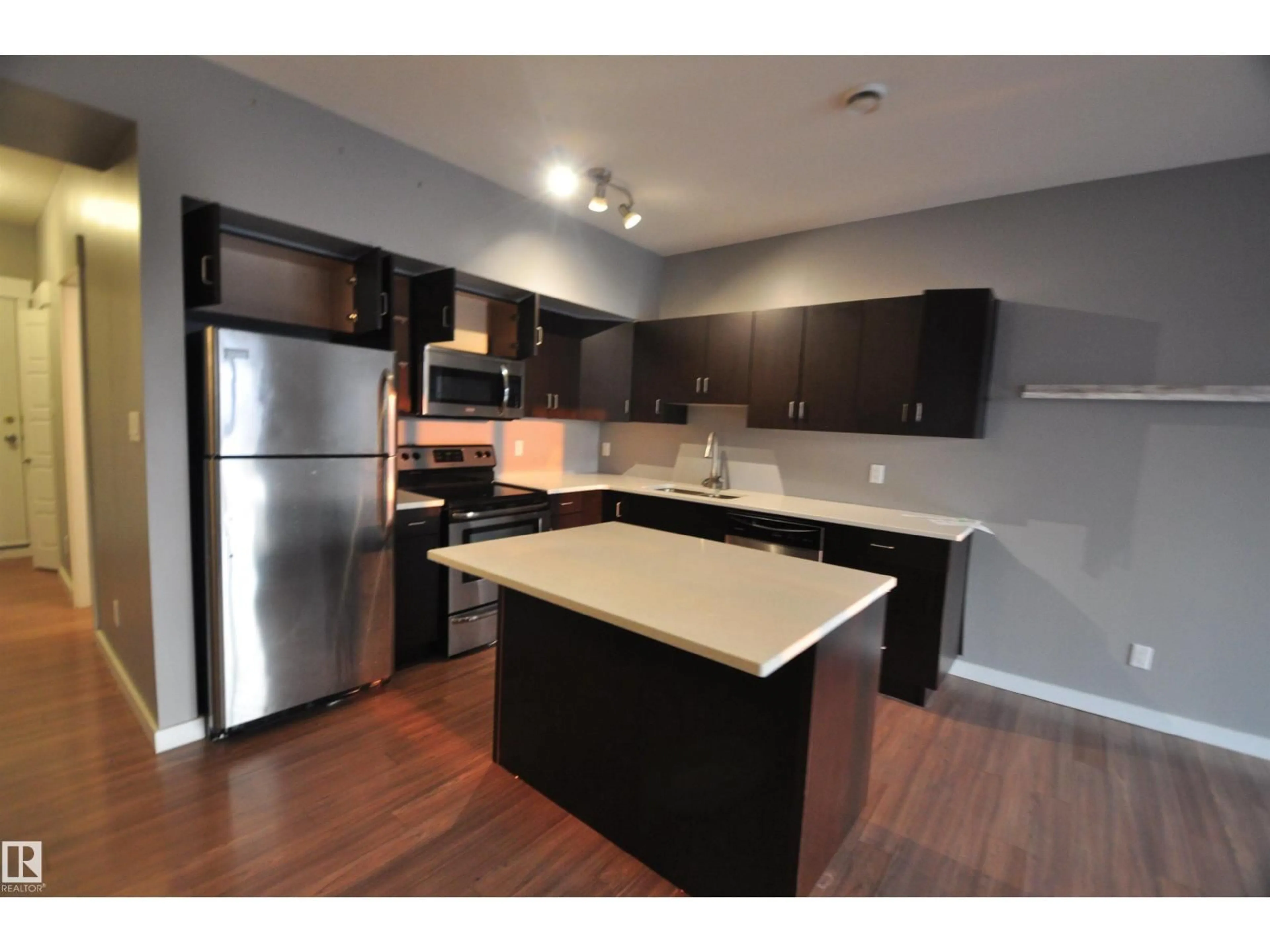 Open concept kitchen, wood/laminate floor for #407 - 10518 113 ST, Edmonton Alberta T5H0C6