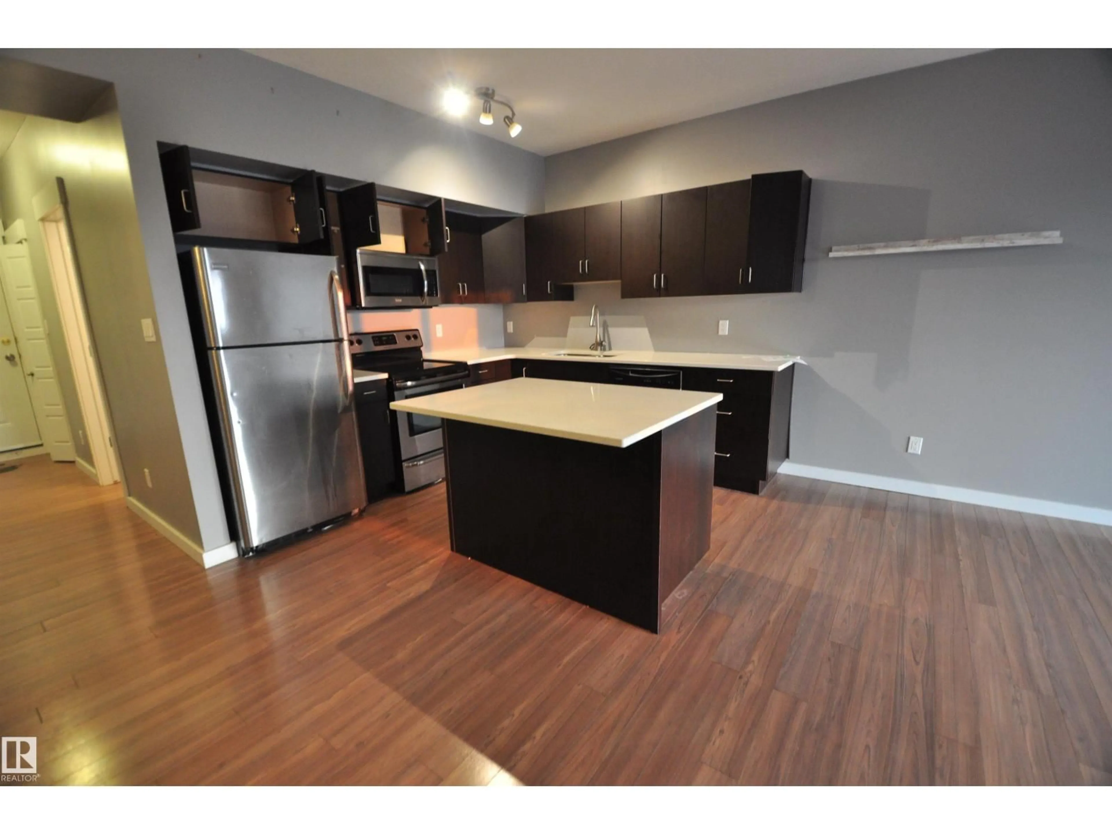 Open concept kitchen, wood/laminate floor for #407 - 10518 113 ST, Edmonton Alberta T5H0C6