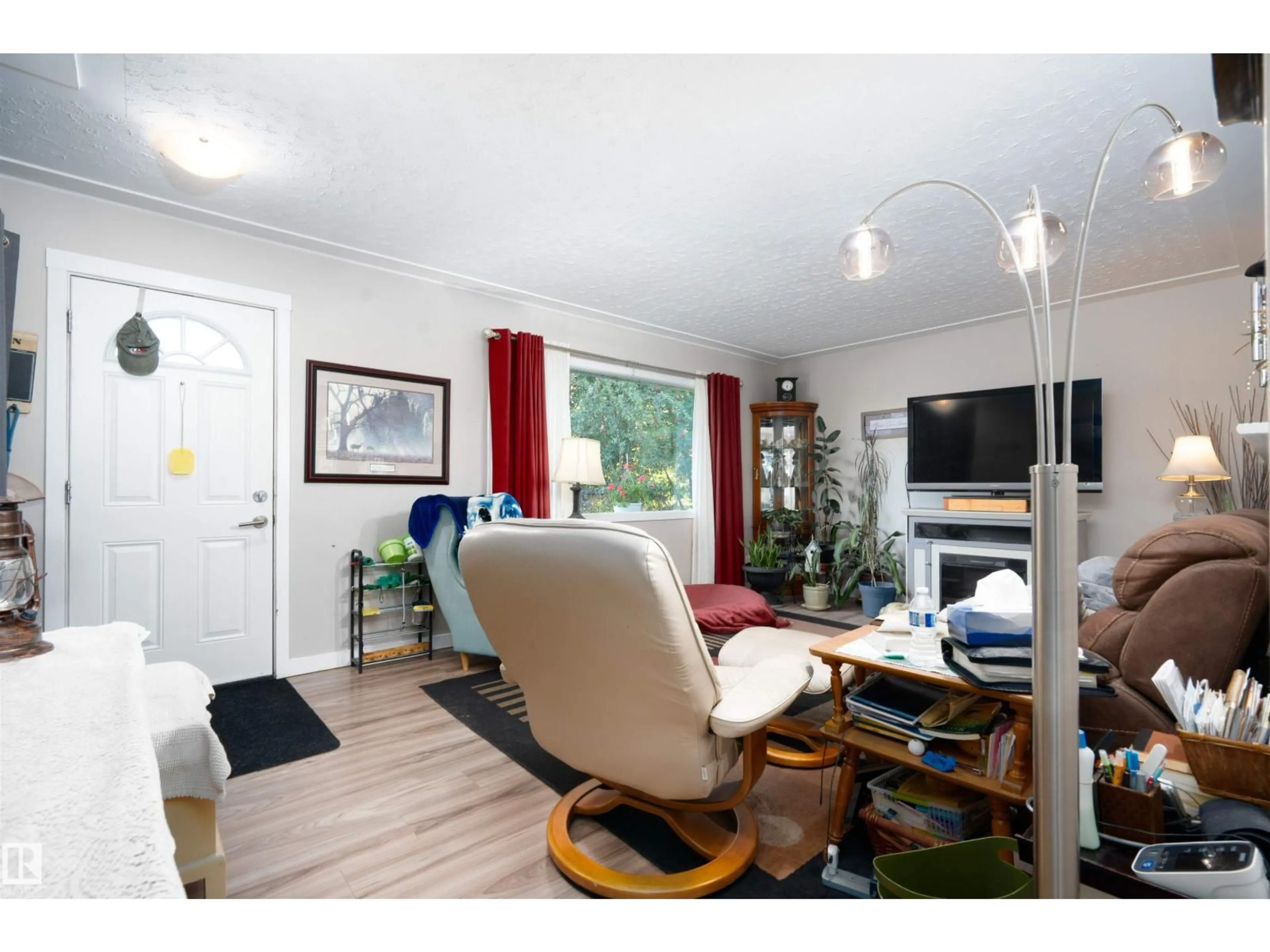 Living room with furniture, wood/laminate floor for 10324 136 AV, Edmonton Alberta T5E1W1