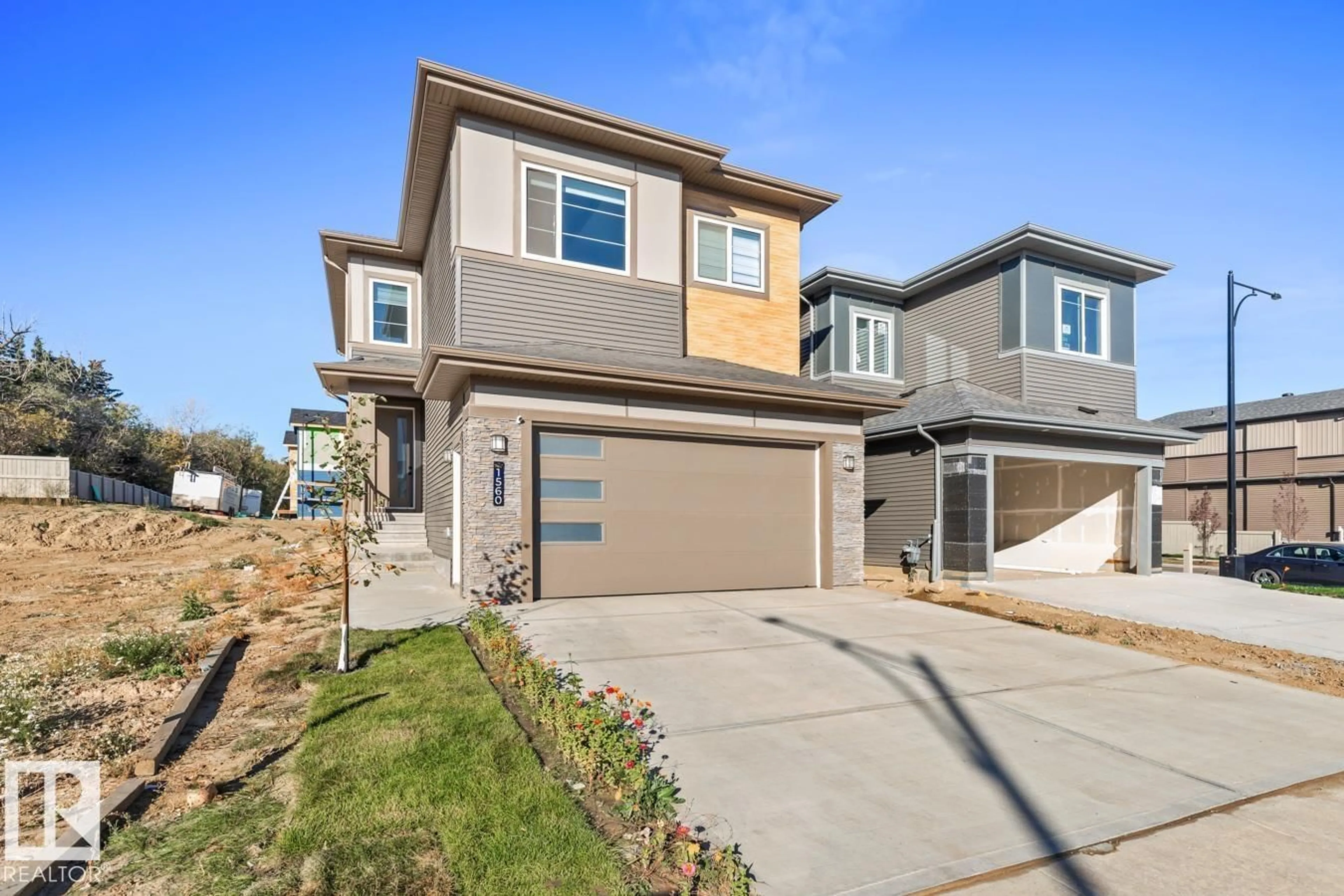 Home with vinyl exterior material, street for 1560 SISKIN LINK, Edmonton Alberta T5S0V1