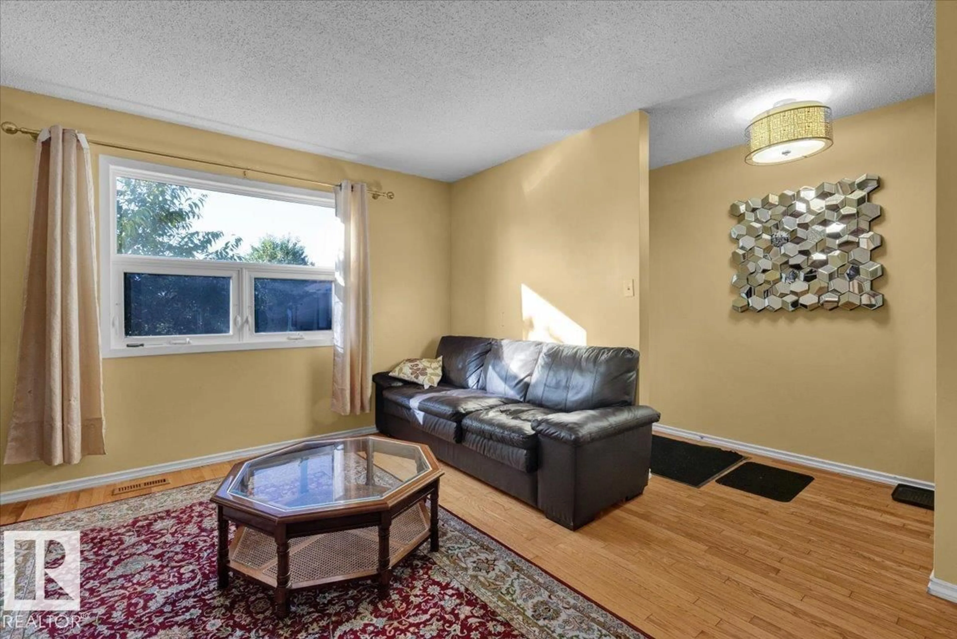 Living room with furniture, wood/laminate floor for 18708 57 AV, Edmonton Alberta T6M2A4