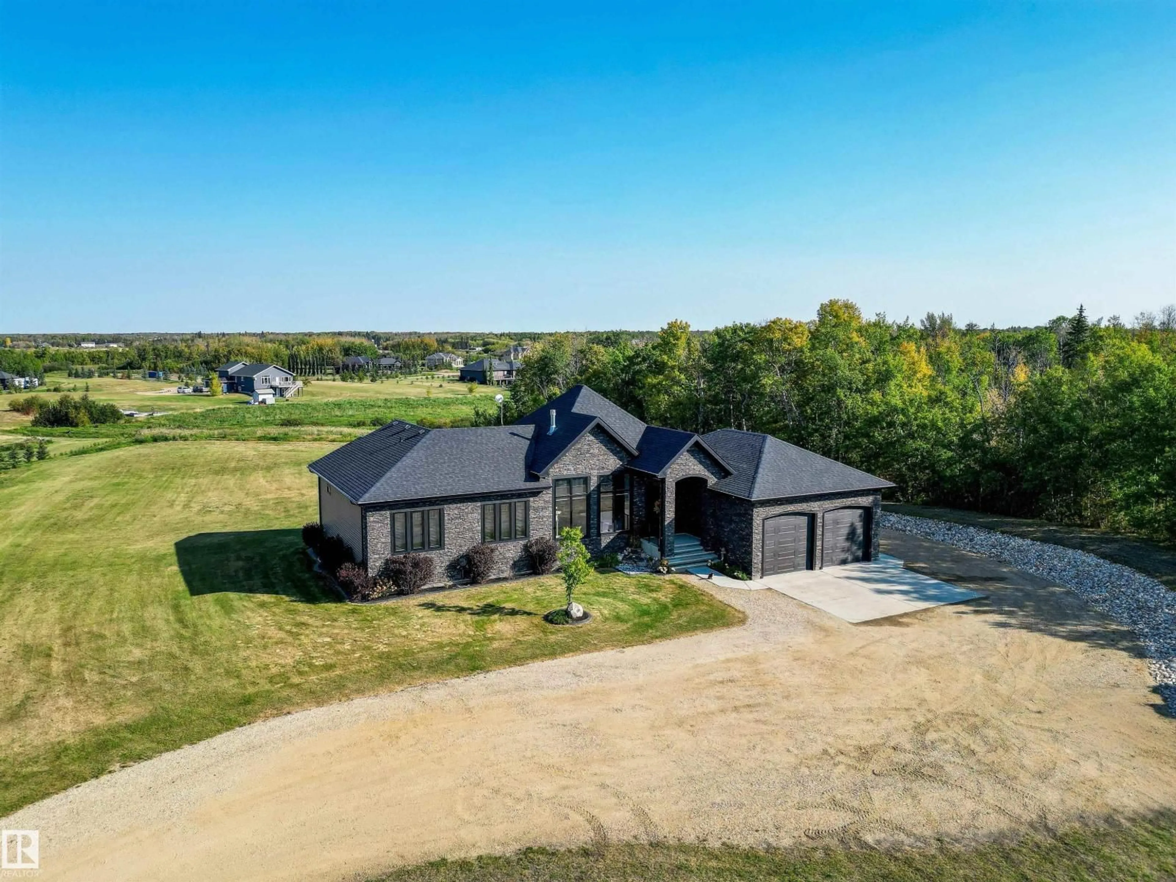A pic from outside/outdoor area/front of a property/back of a property/a pic from drone, water/lake/river/ocean view for 100 50054 RGE ROAD 232, Rural Leduc County Alberta T4X0K8