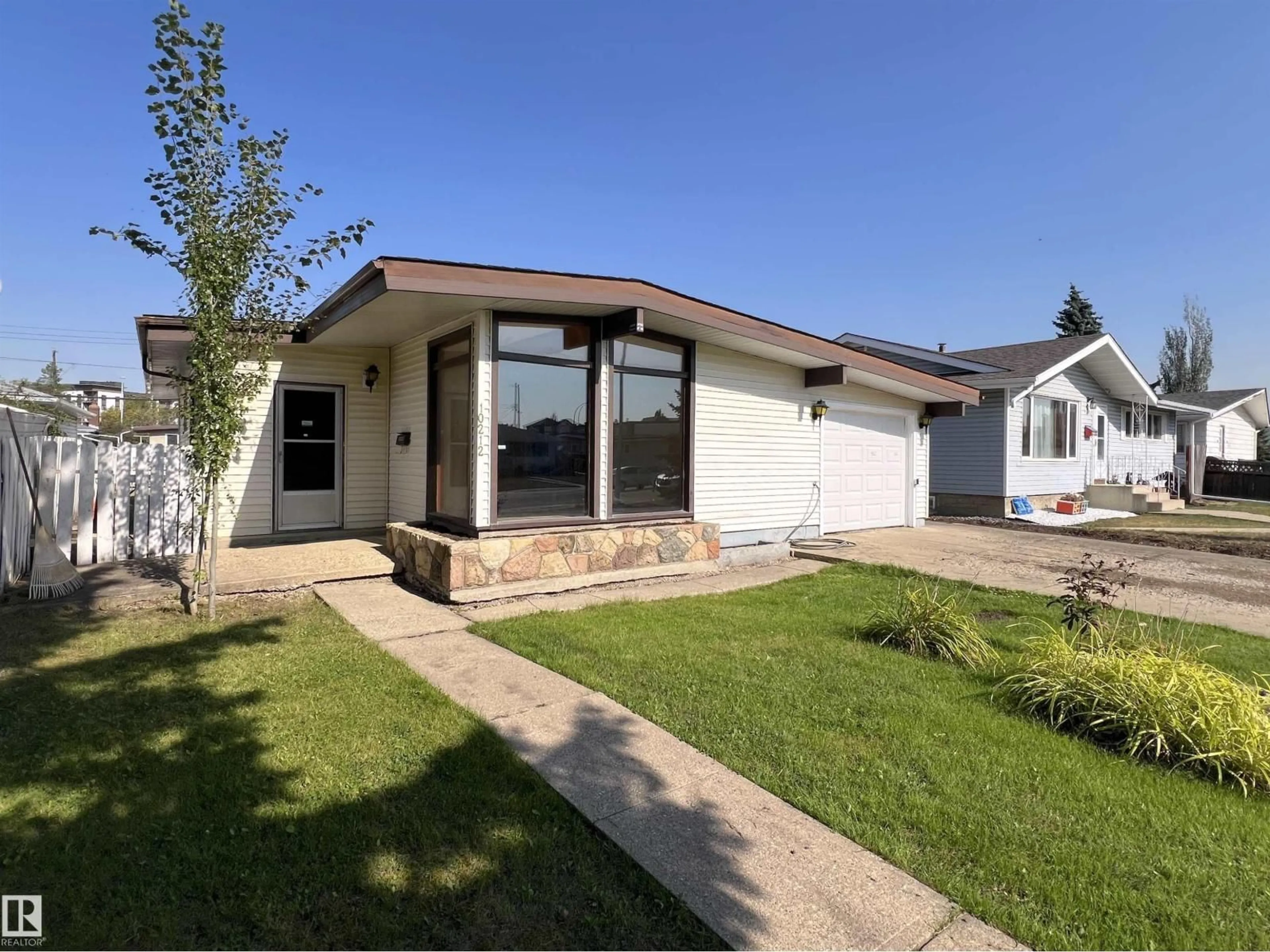 Home with vinyl exterior material, street for 10212 136 AV, Edmonton Alberta T5E1W1