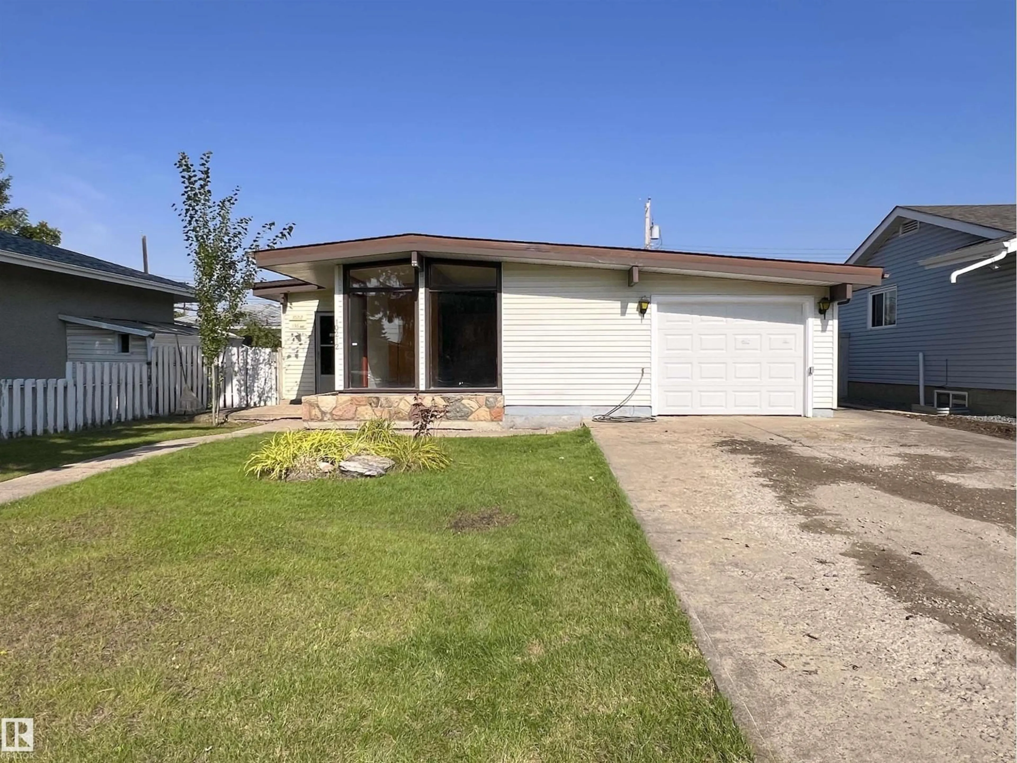 Home with vinyl exterior material, street for 10212 136 AV, Edmonton Alberta T5E1W1