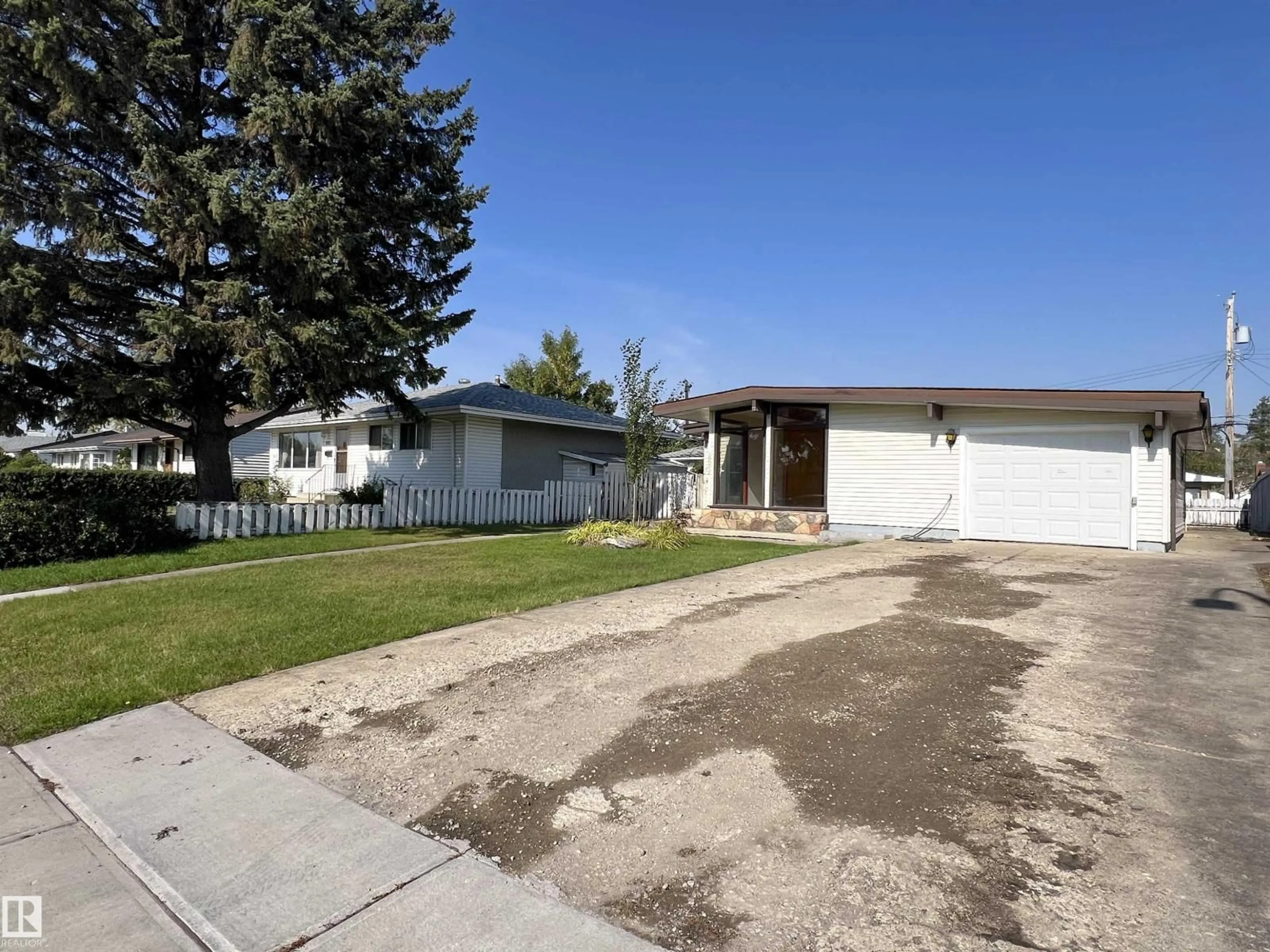 Home with vinyl exterior material, street for 10212 136 AV, Edmonton Alberta T5E1W1