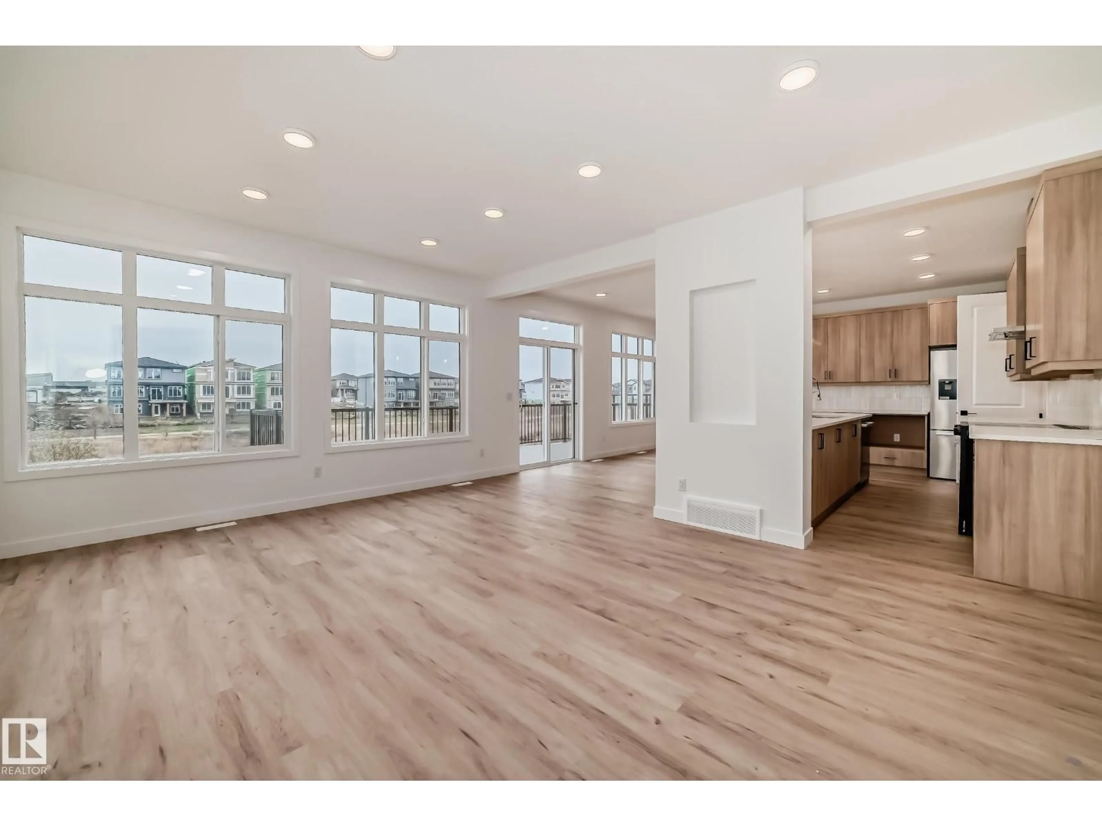 Open concept kitchen, wood/laminate floor for SW - 5815 KOOTOOK LI, Edmonton Alberta T6W4V9