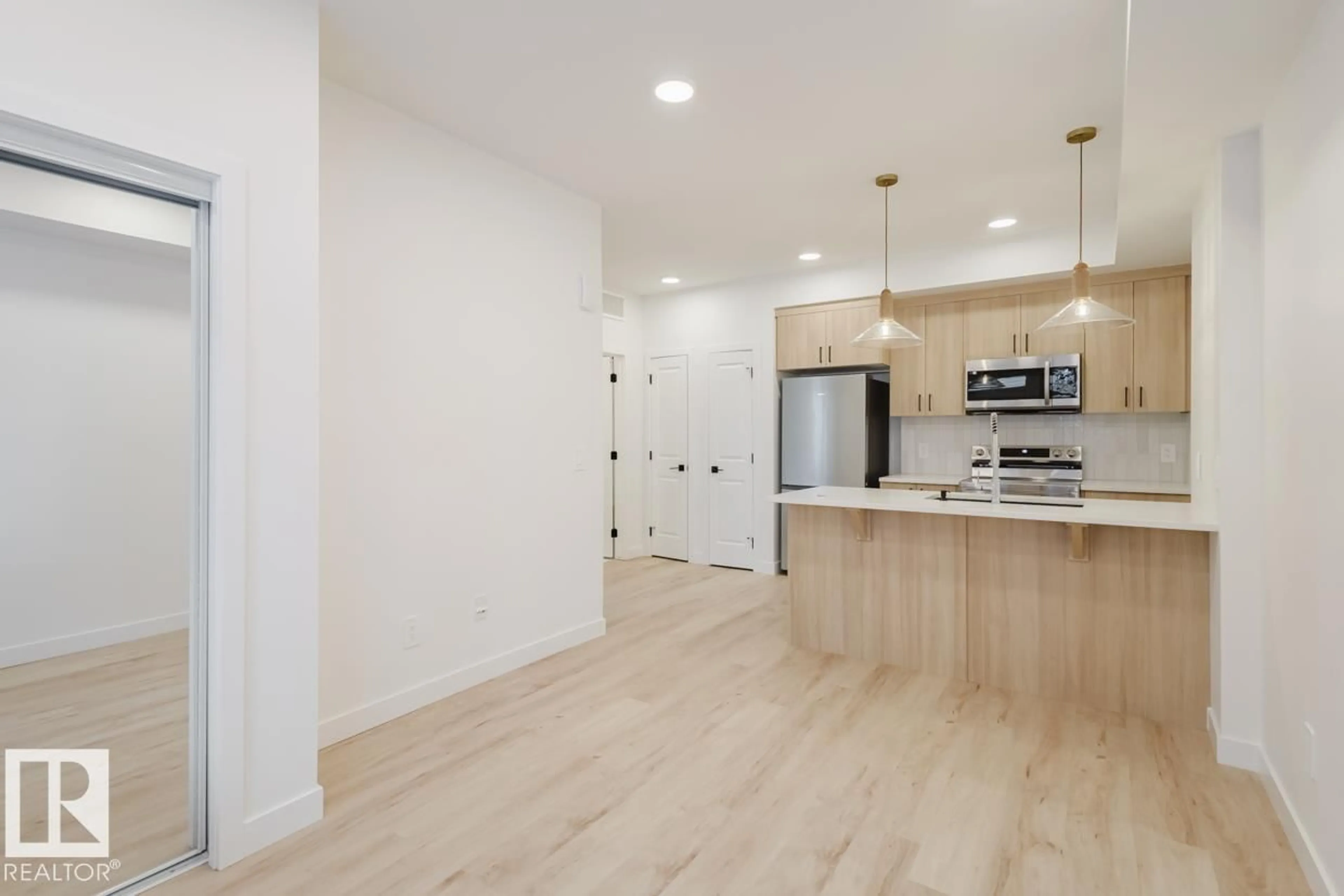 Open concept kitchen, wood/laminate floor for 19 16231 19 AV SW, Edmonton Alberta T6W5C6