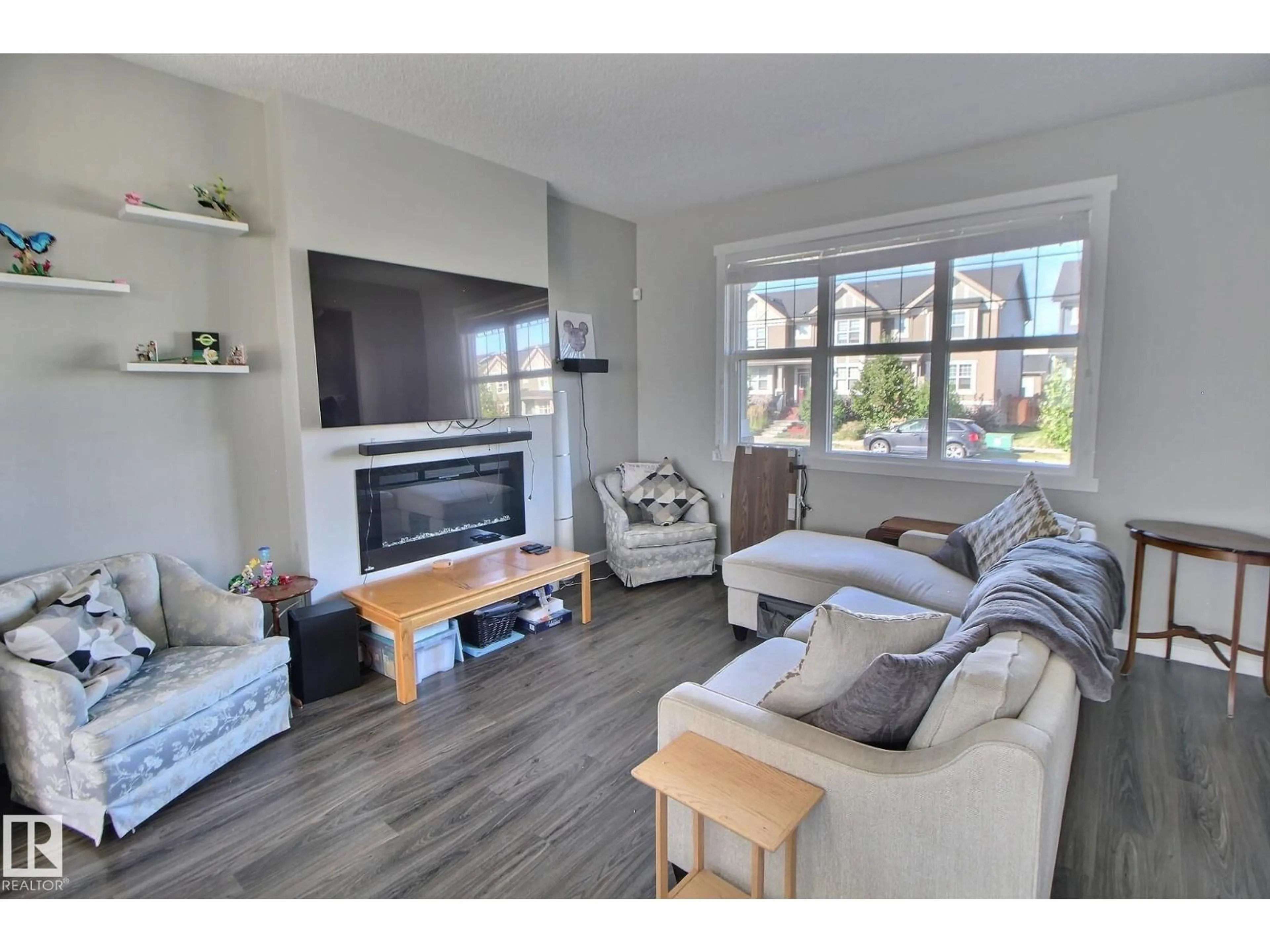Living room with furniture, wood/laminate floor for 2271 GLENRIDDING BV, Edmonton Alberta T6W3P4