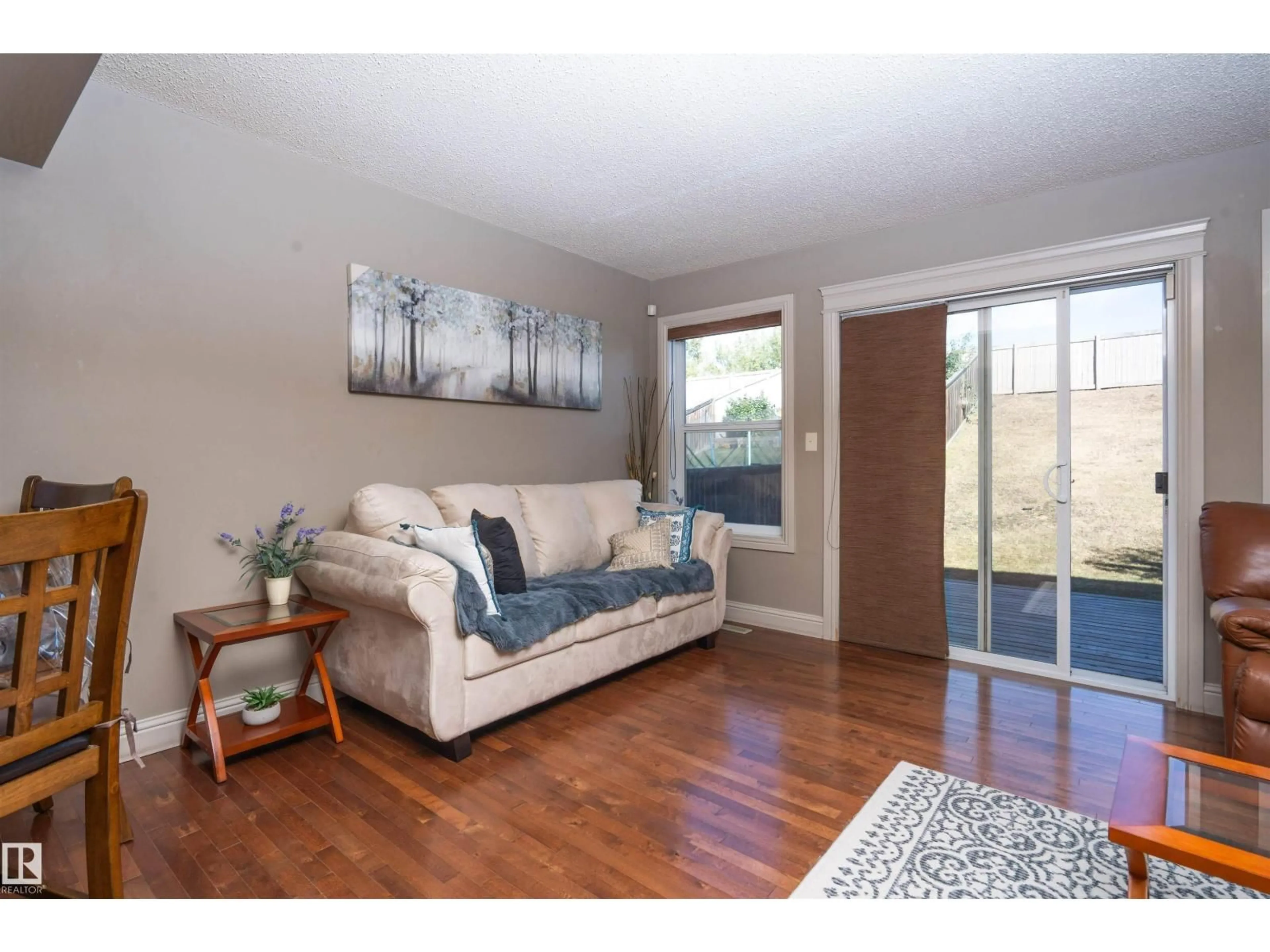 Living room with furniture, wood/laminate floor for 3533 11 ST, Edmonton Alberta T6T0J7