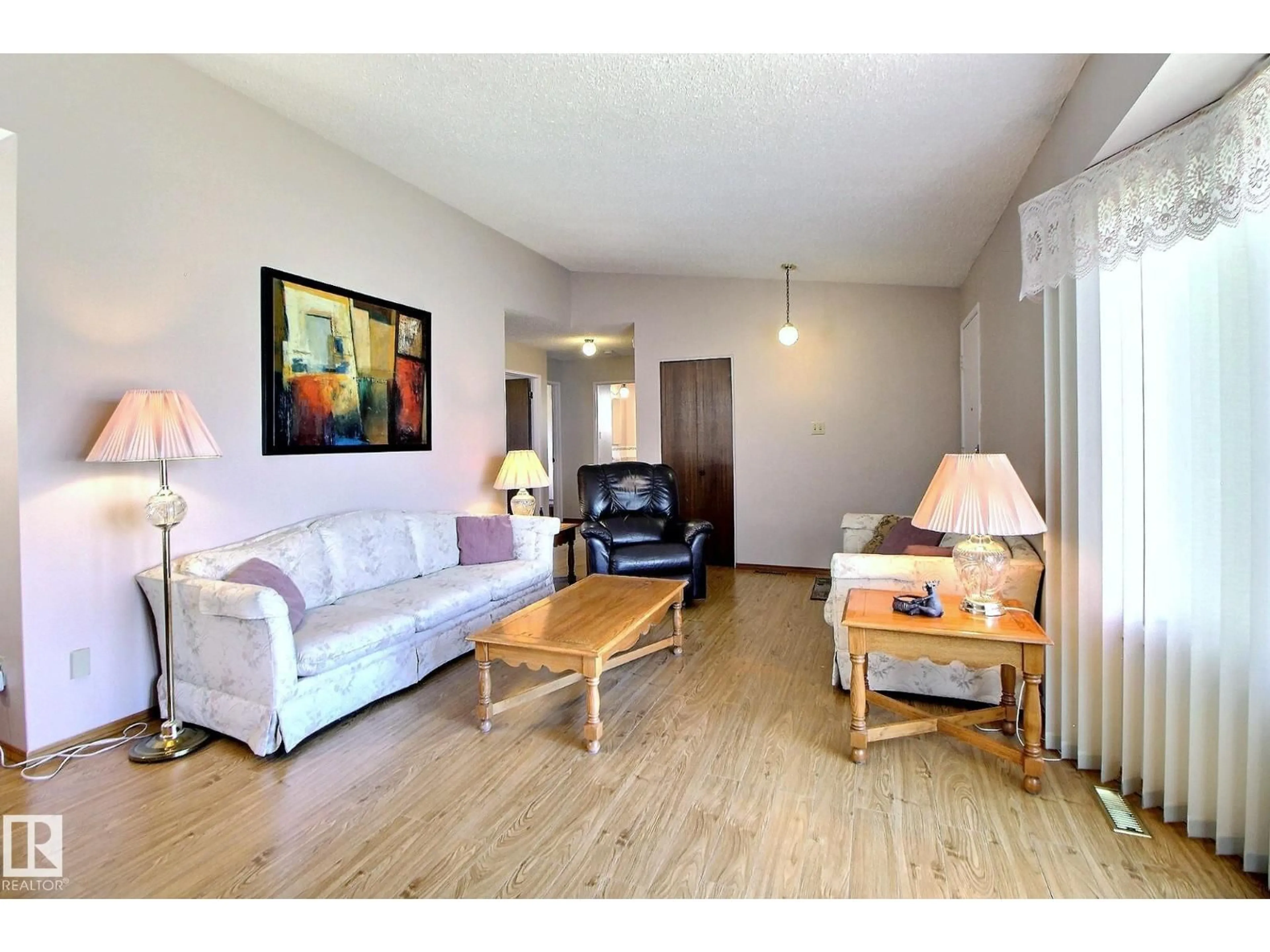 Living room with furniture, wood/laminate floor for NW - 15208 58 ST, Edmonton Alberta T5A2M2