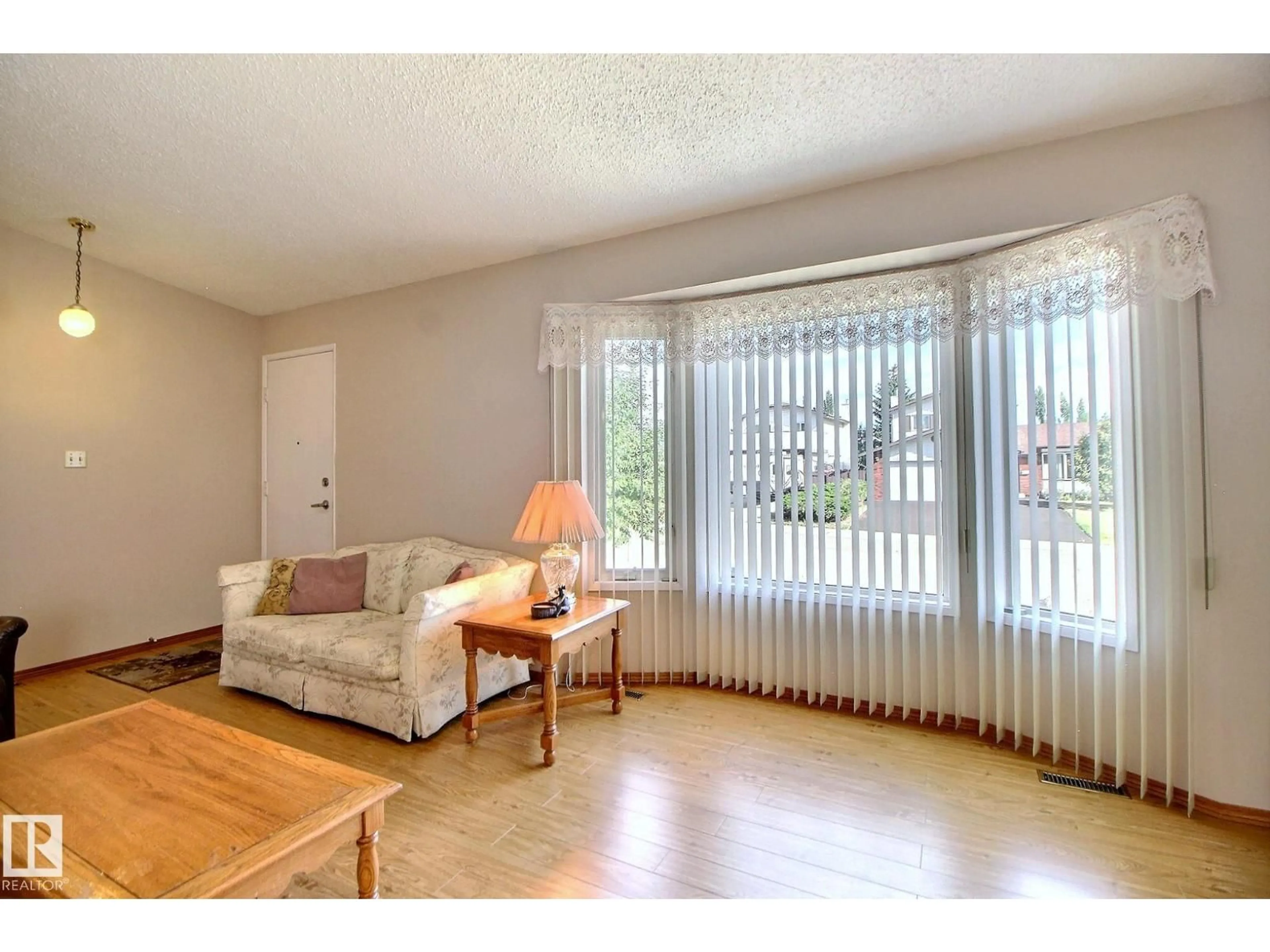 Living room with furniture, wood/laminate floor for NW - 15208 58 ST, Edmonton Alberta T5A2M2