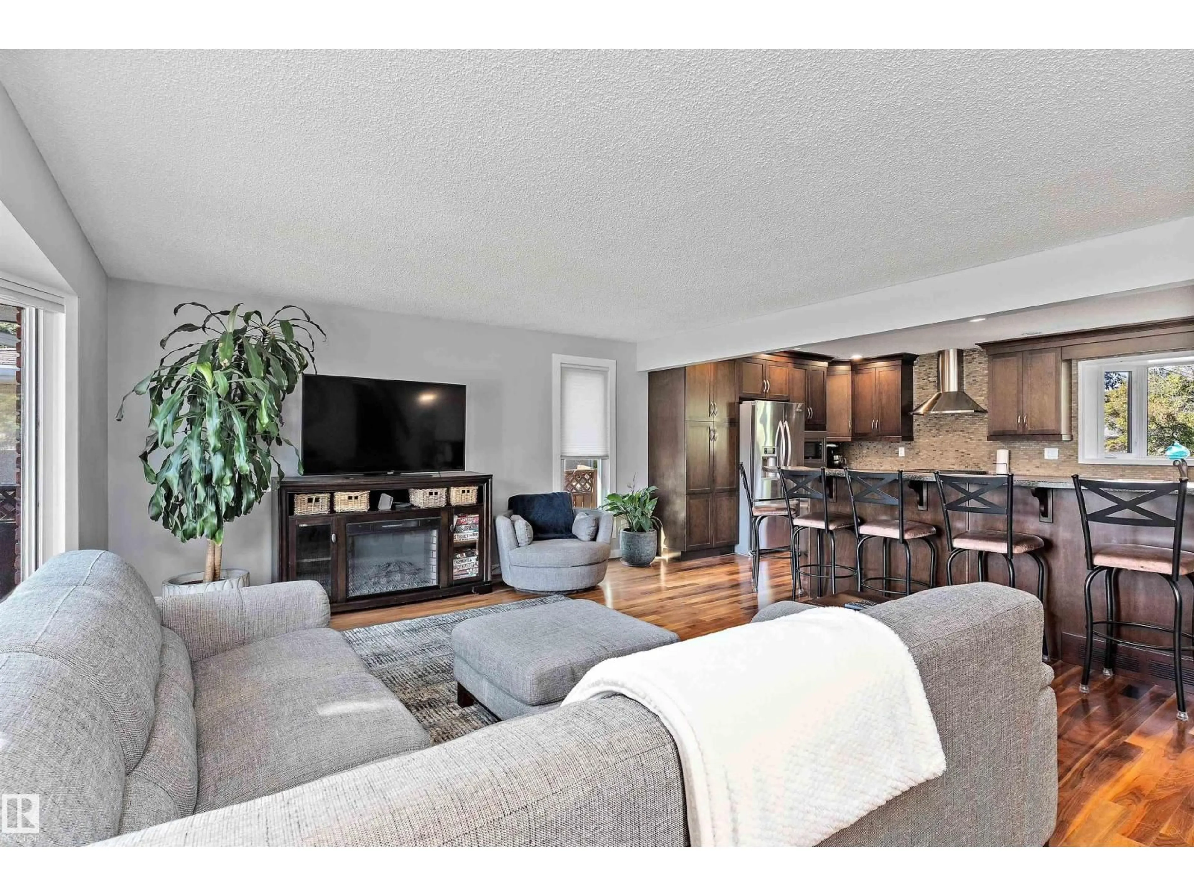 Living room with furniture, wood/laminate floor for 11174 35 AV, Edmonton Alberta T6J3N1