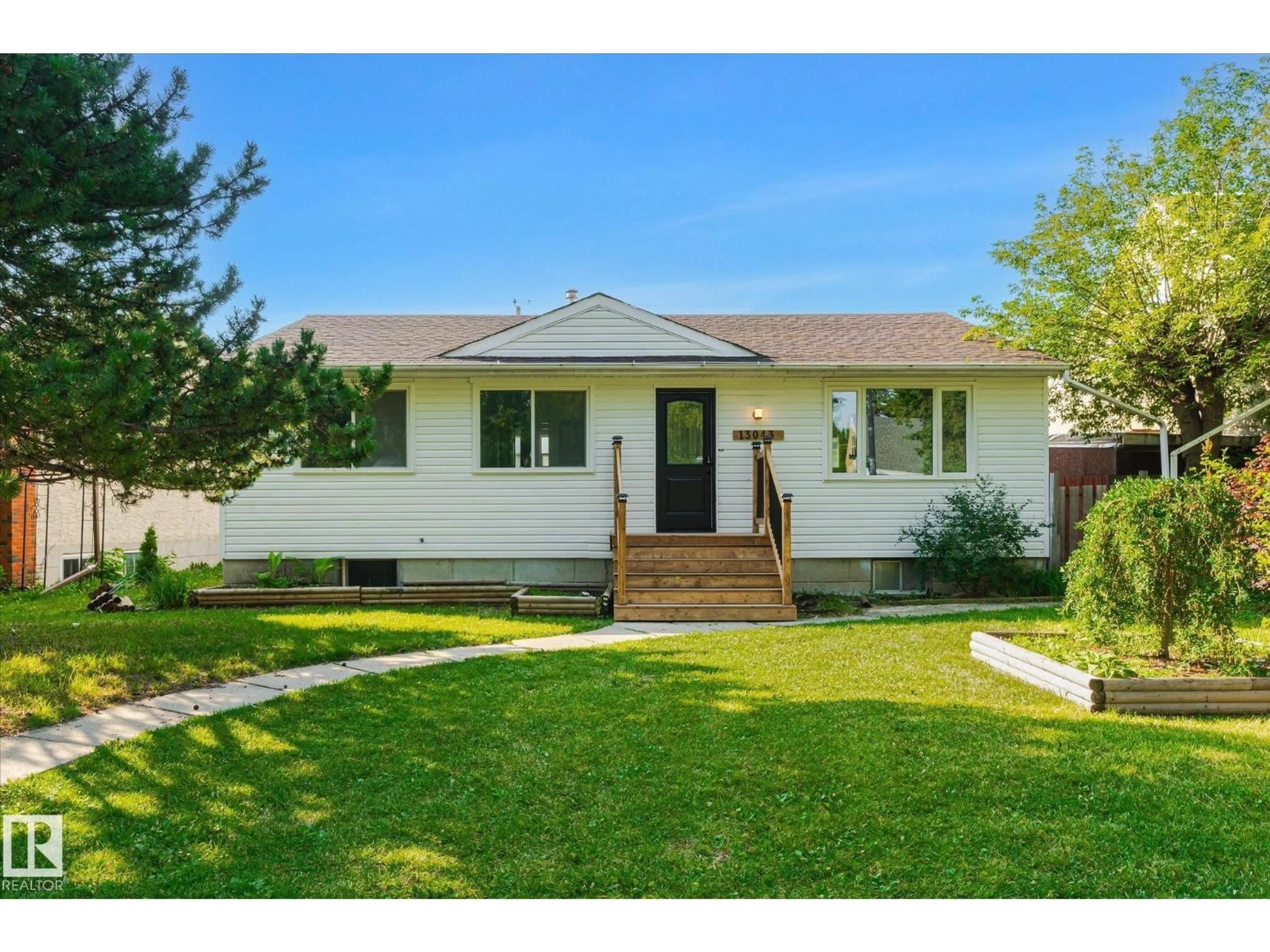 Home with vinyl exterior material, street for 13043 SHERBROOKE AV, Edmonton Alberta T5L4E6