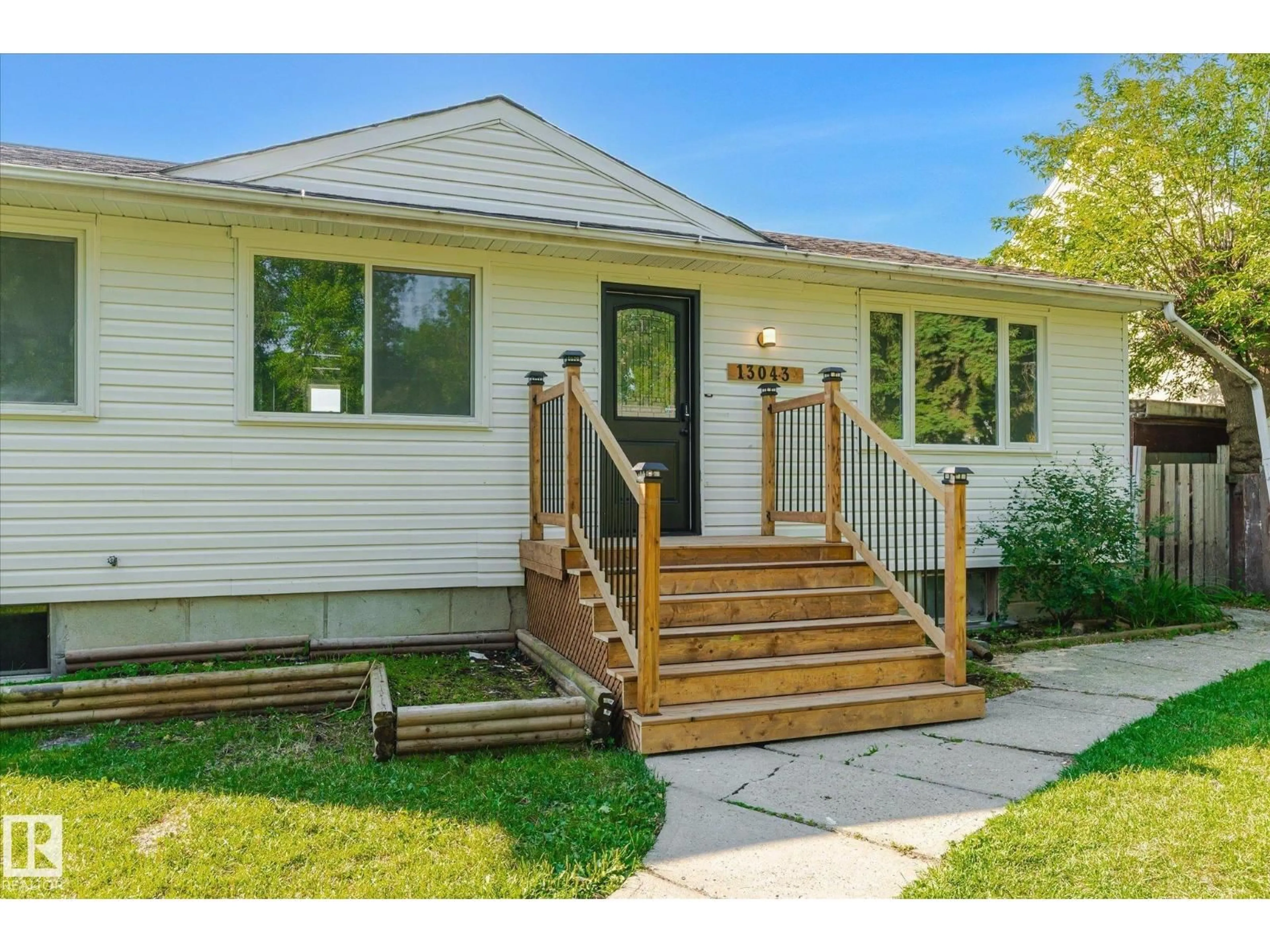 Home with vinyl exterior material, street for 13043 SHERBROOKE AV, Edmonton Alberta T5L4E6